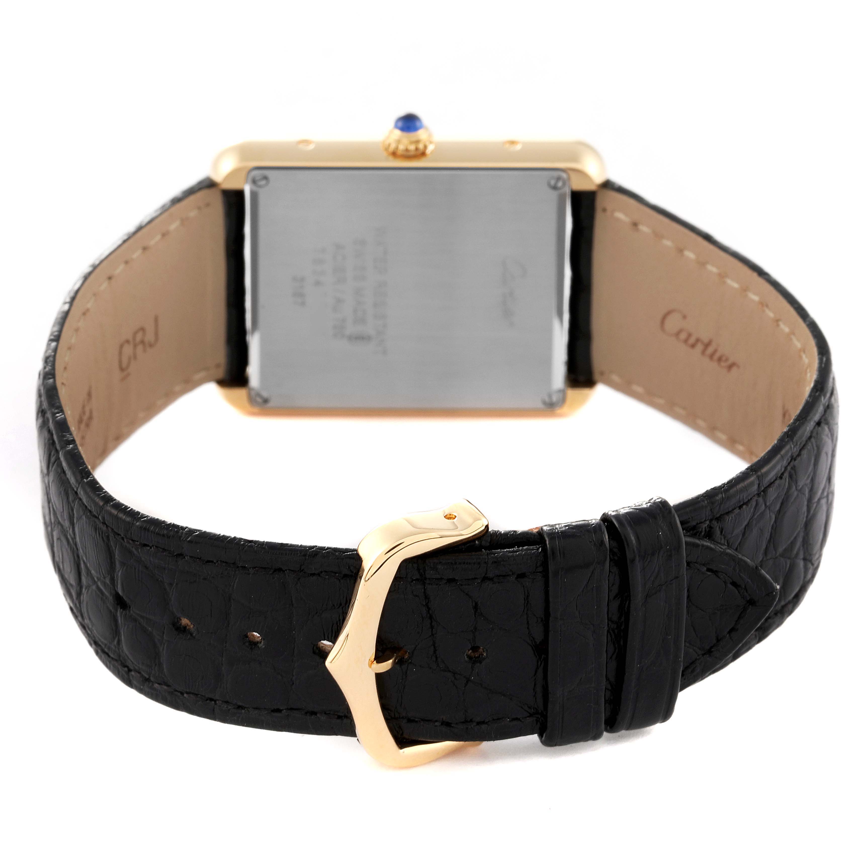 The image shows the back of a Cartier Tank Solo W5200004 Men
s Yellow Gold Silver Dial W5200004 Men
s Yellow Gold Silver Dial watch, highlighting its case back, leather strap, and clasp.