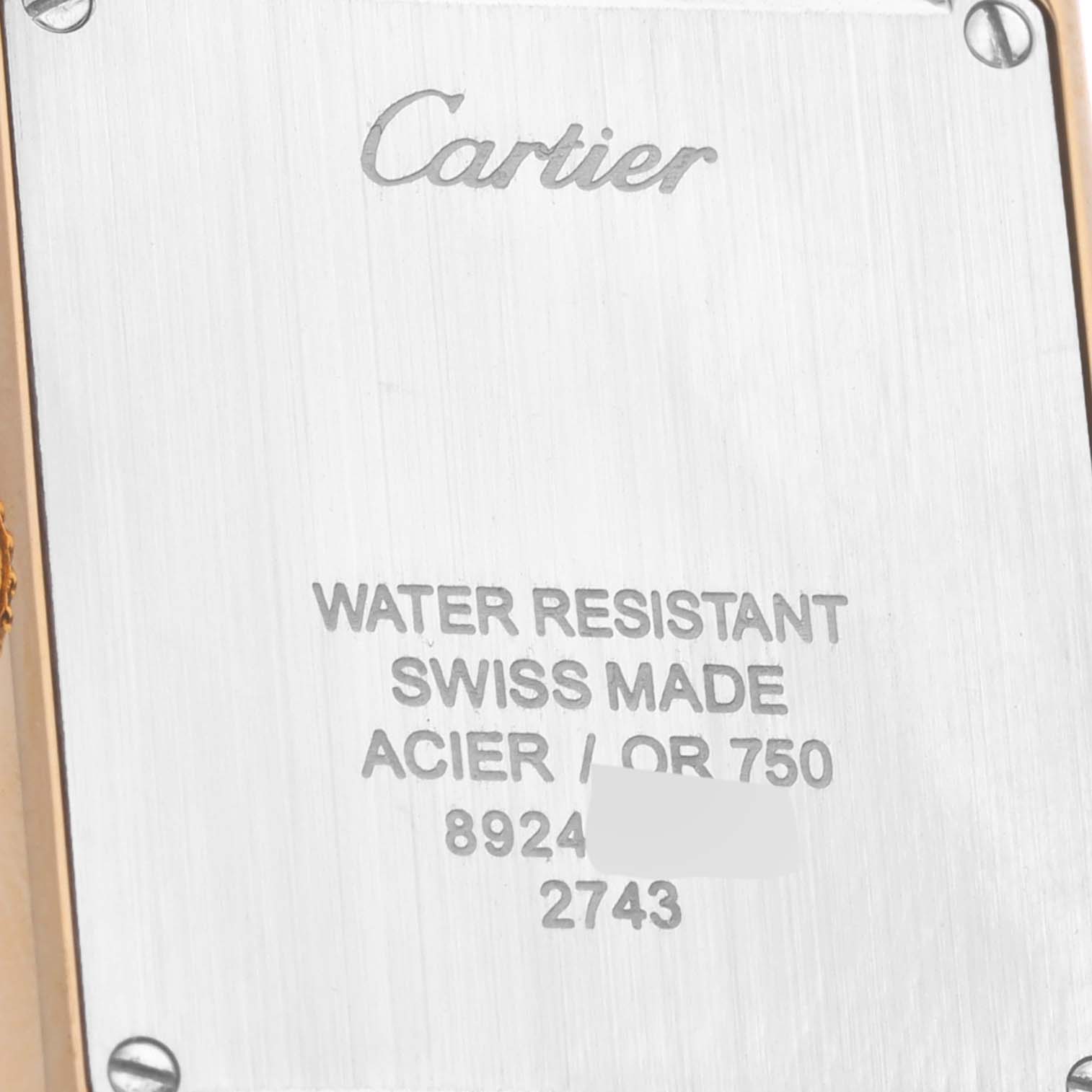 This image shows the engraved stainless steel back case of a Cartier Tank Solo W1018755 Women
s Steel and Gold (two tone) Silver Dial W1018755 Women
s Steel and Gold (two tone) Silver Dial watch, featuring brand and model information.