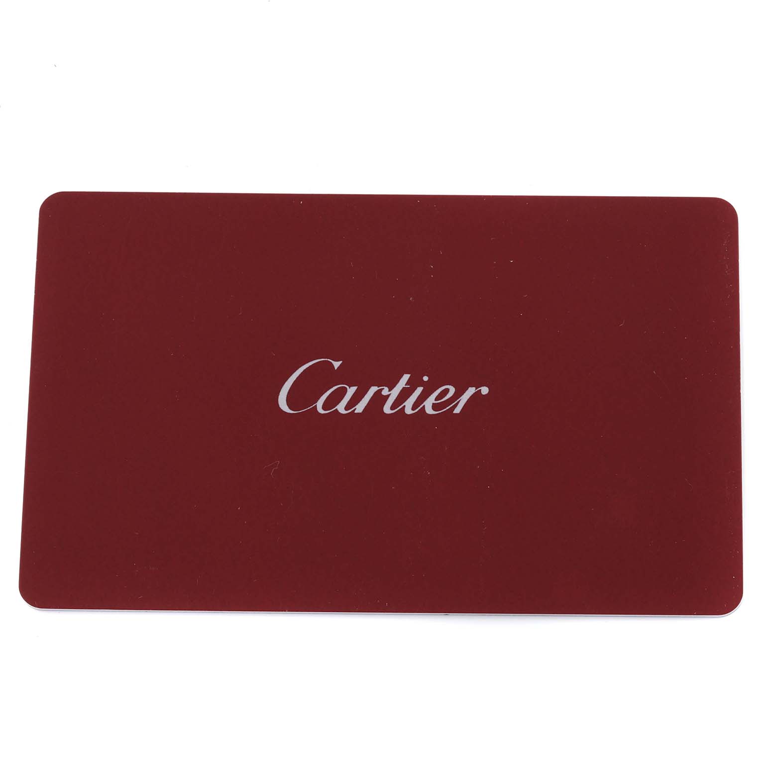 This image shows a red card with the brand name "Cartier," likely an accessory or certificate for the Tank Solo model.