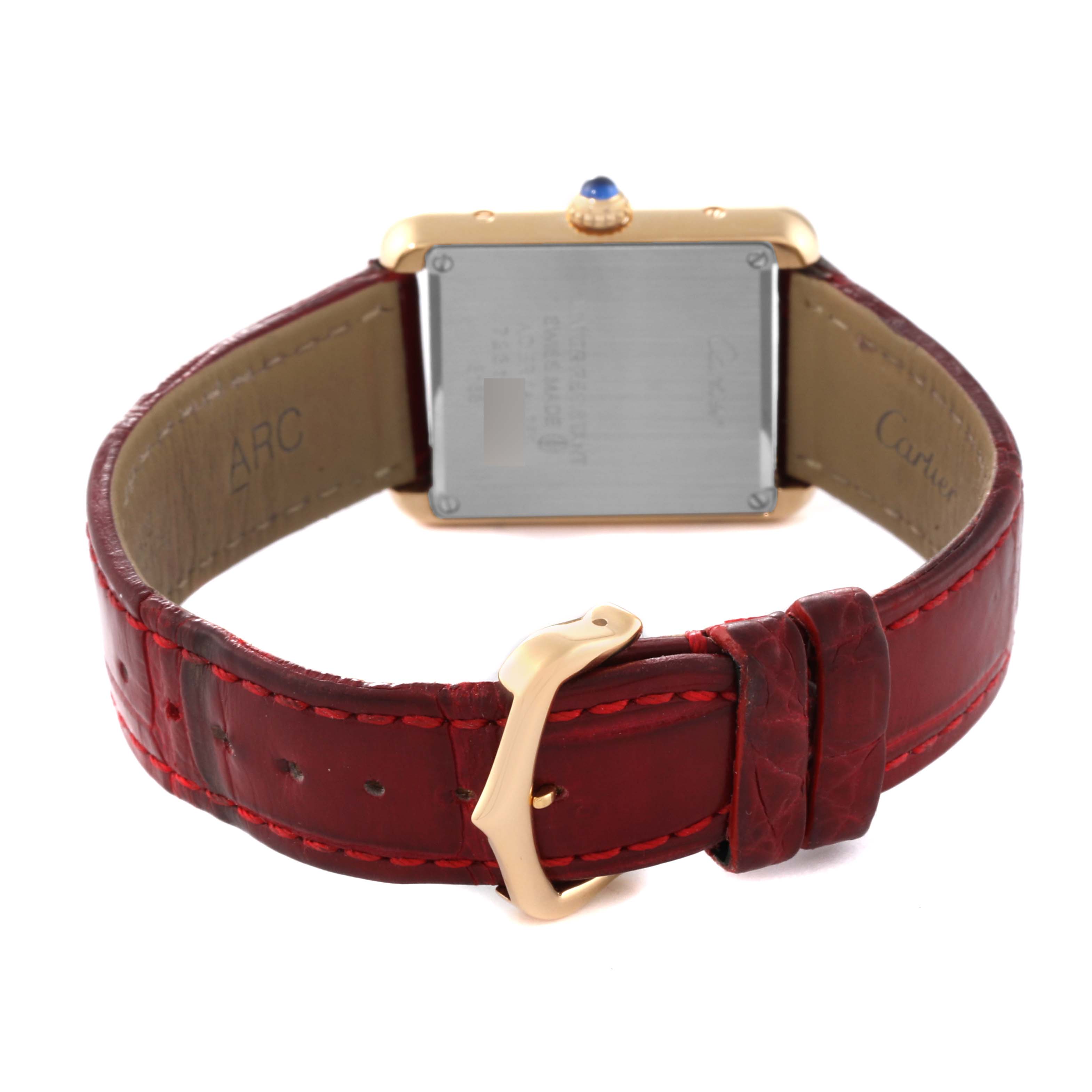 This image shows the back side of a Cartier Tank Solo W5200002 Women's Steel and Gold (two tone) Silver Dial W5200002 Women's Steel and Gold (two tone) Silver Dial watch with its red leather strap and buckle.