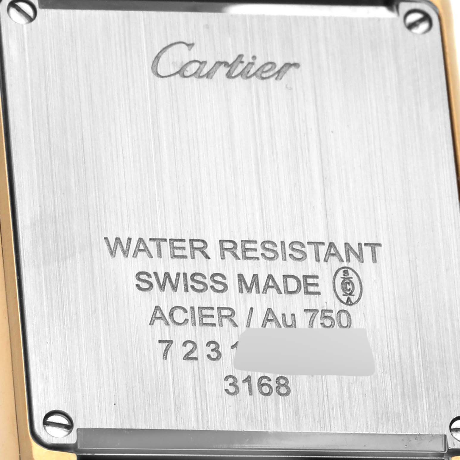This image shows the back case of a Cartier Tank Solo W5200002 Women's Steel and Gold (two tone) Silver Dial W5200002 Women's Steel and Gold (two tone) Silver Dial watch, highlighting its engraved details and screws.