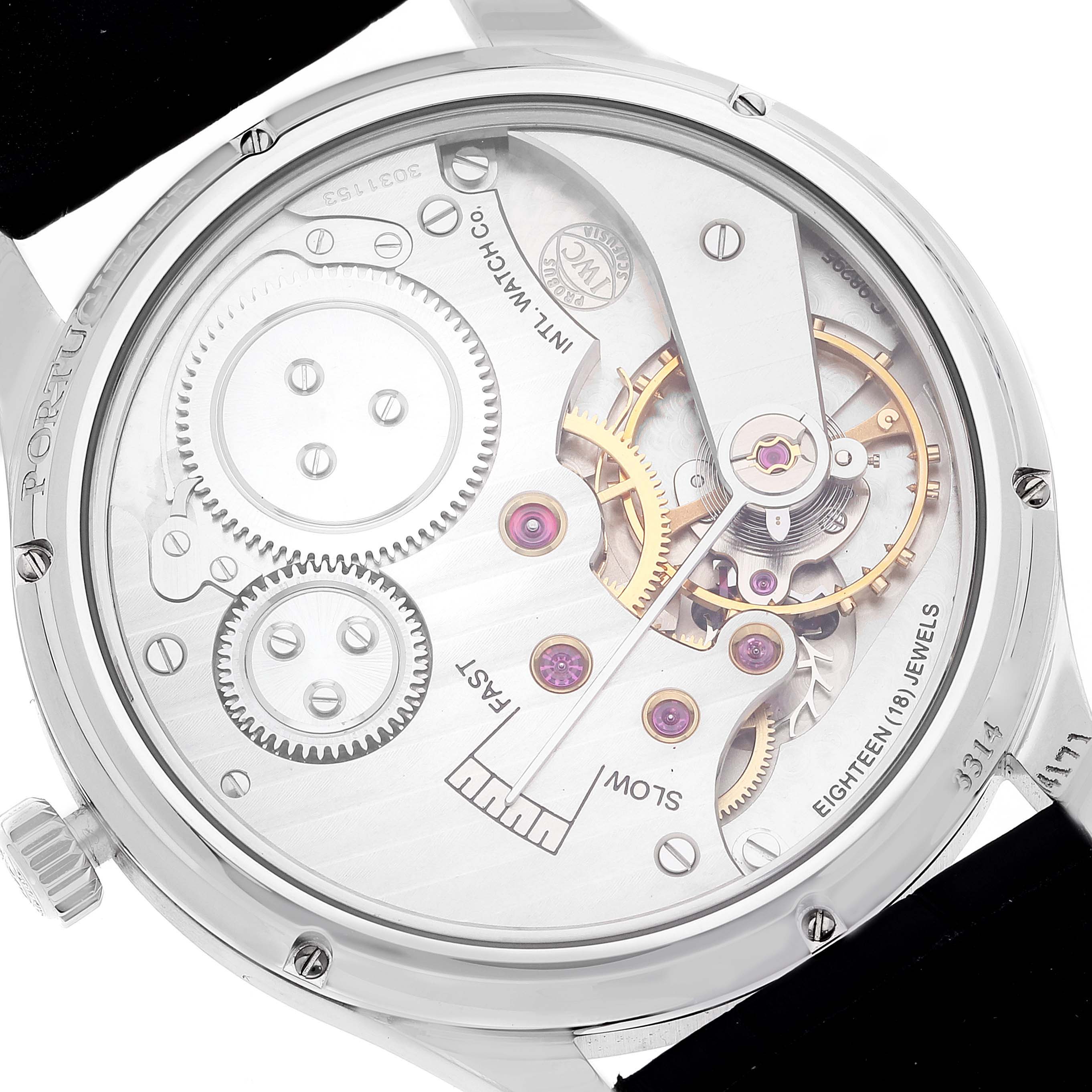 The image shows the back view of an IWC Portuguese IW544501 Men's Stainless Steel Black Dial model watch, displaying its intricate movement and mechanics.