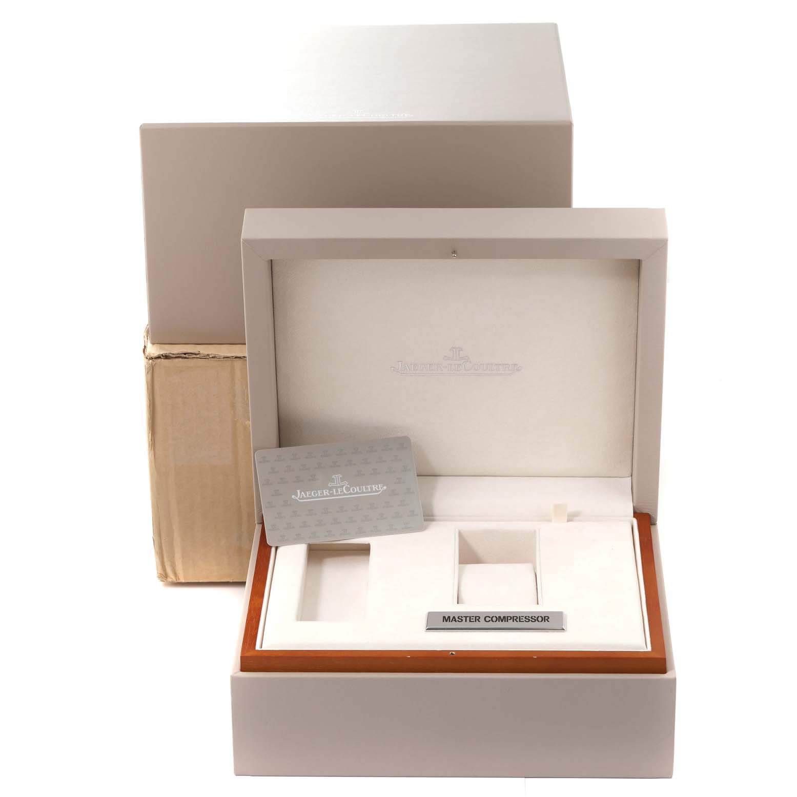 The image shows the open packaging box for a Jaeger-LeCoultre Master Compressor watch, including the inner display box and documentation.