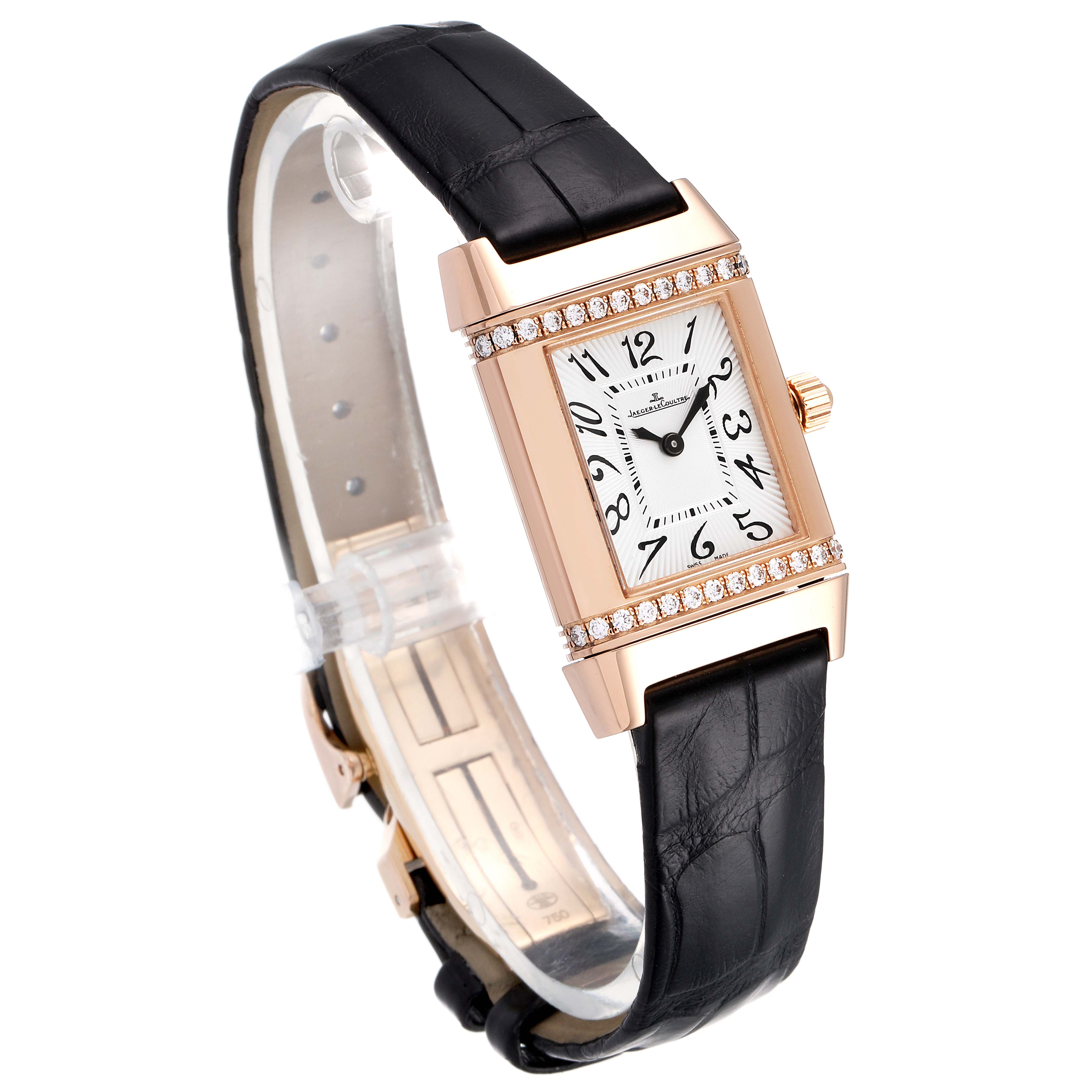 The Jaeger LeCoultre Reverso Q2651430 Women's Rose Gold Silver Dial Q2651430 Women's Rose Gold Silver Dial watch is shown at a 3/4 angle, highlighting its rectangular face, leather strap, and diamond accents.