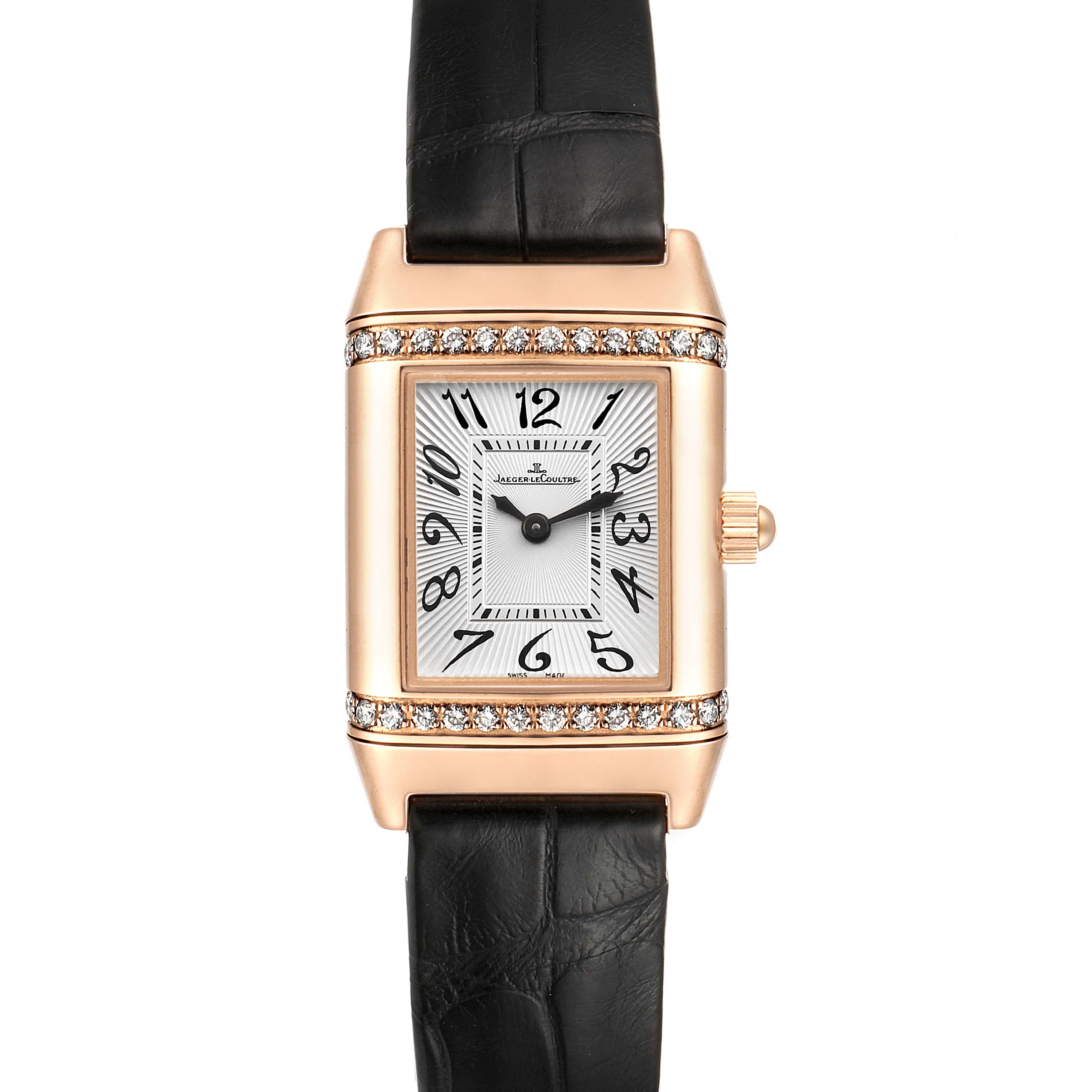 The image shows a Jaeger-LeCoultre Reverso model watch from a front angle, highlighting its face, black strap, and diamond-adorned rectangular case.
