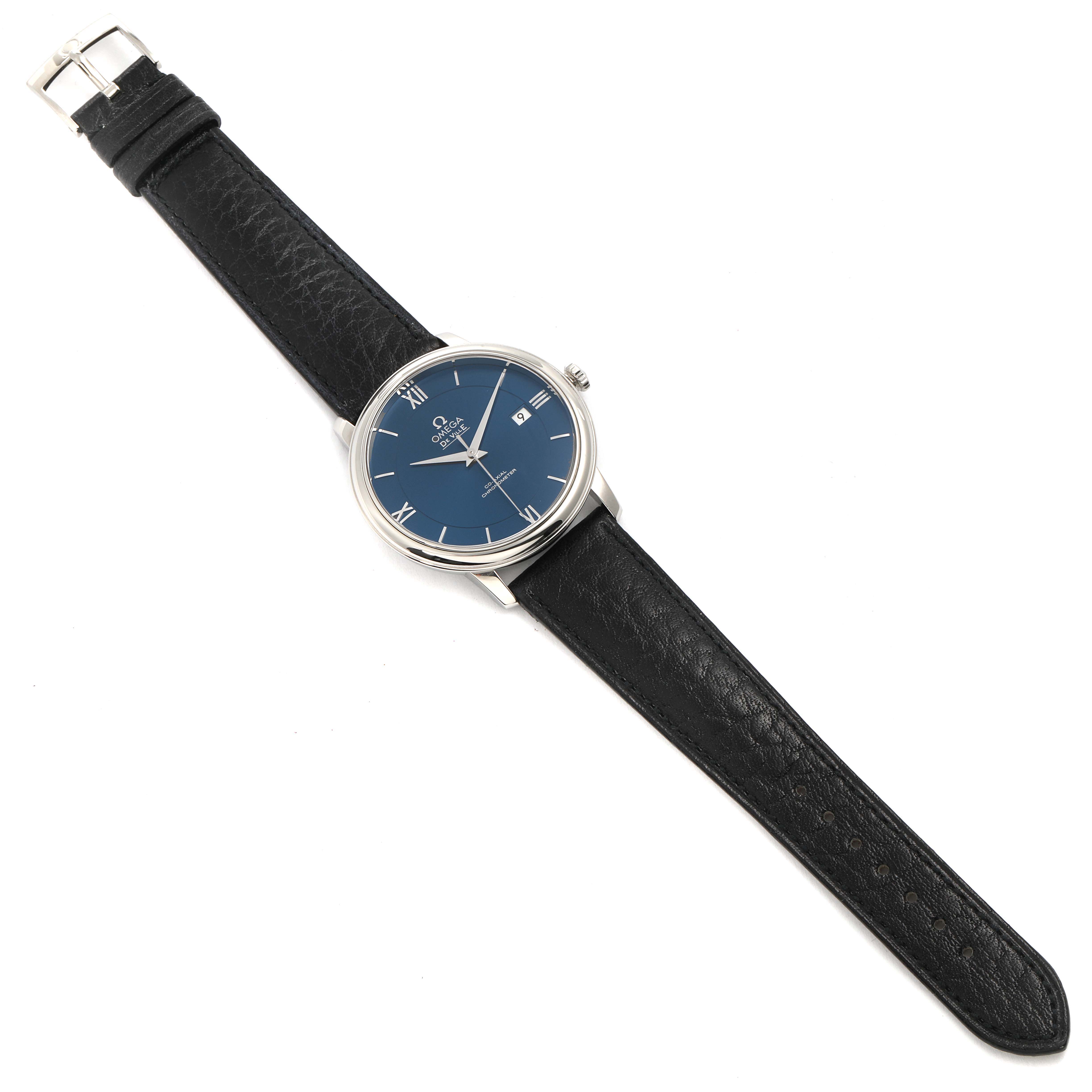 The image shows an Omega De Ville 424.13.40.20.03.001 Men's Stainless Steel Blue Dial 424.13.40.20.03.001 Men's Stainless Steel Blue Dial watch with a blue dial, black leather strap, and a silver buckle, viewed from a top-down angle.