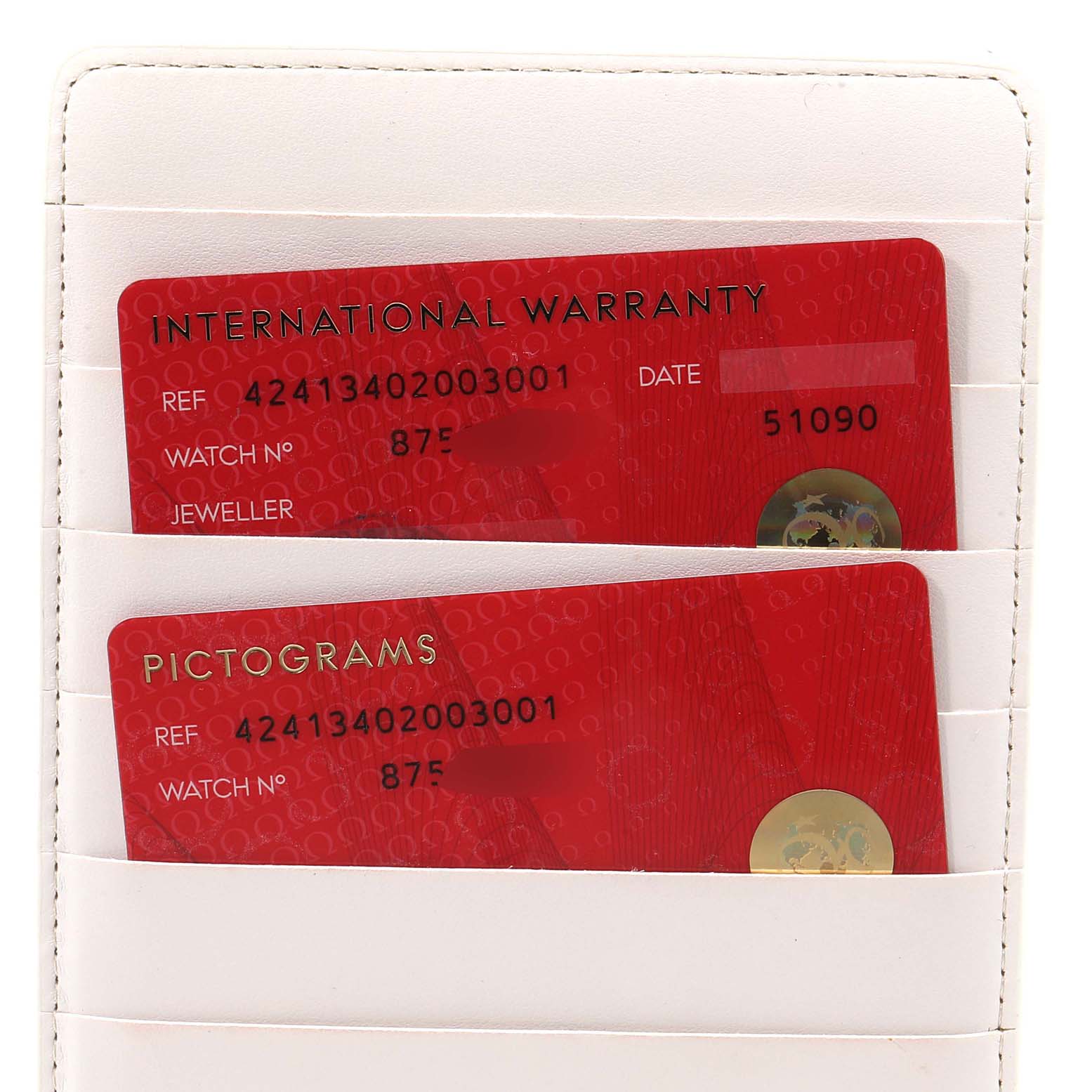 The image shows a close-up of the warranty and pictogram cards for an Omega De Ville 424.13.40.20.03.001 Men's Stainless Steel Blue Dial 424.13.40.20.03.001 Men's Stainless Steel Blue Dial watch.