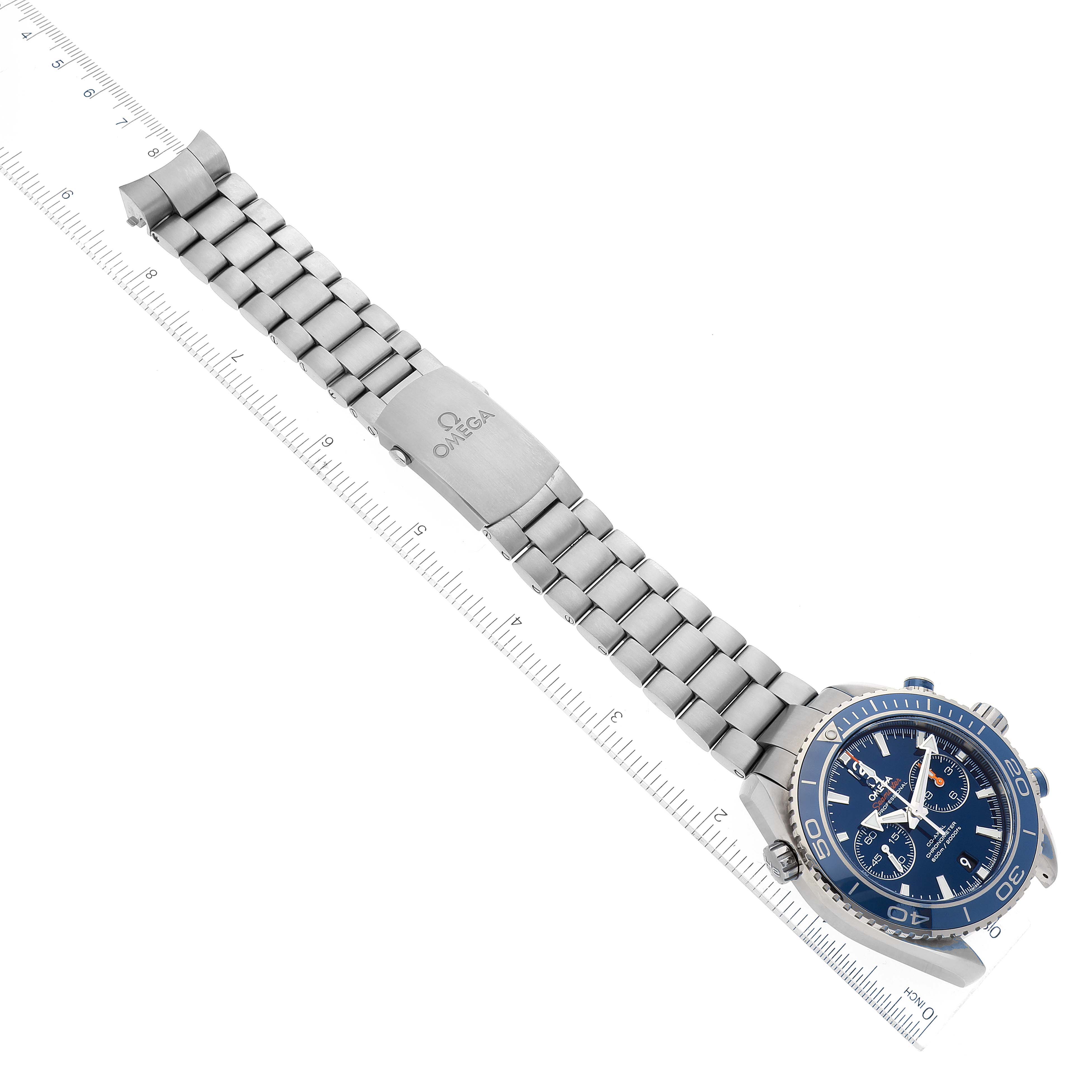 The image shows the Omega Planet Ocean 232.90.46.51.03.001 Men
s Titanium Blue Dial 232.90.46.51.03.001 Men
s Titanium Blue Dial watch laid flat, showcasing its stainless steel bracelet, clasp, and blue dial from a top-down angle.