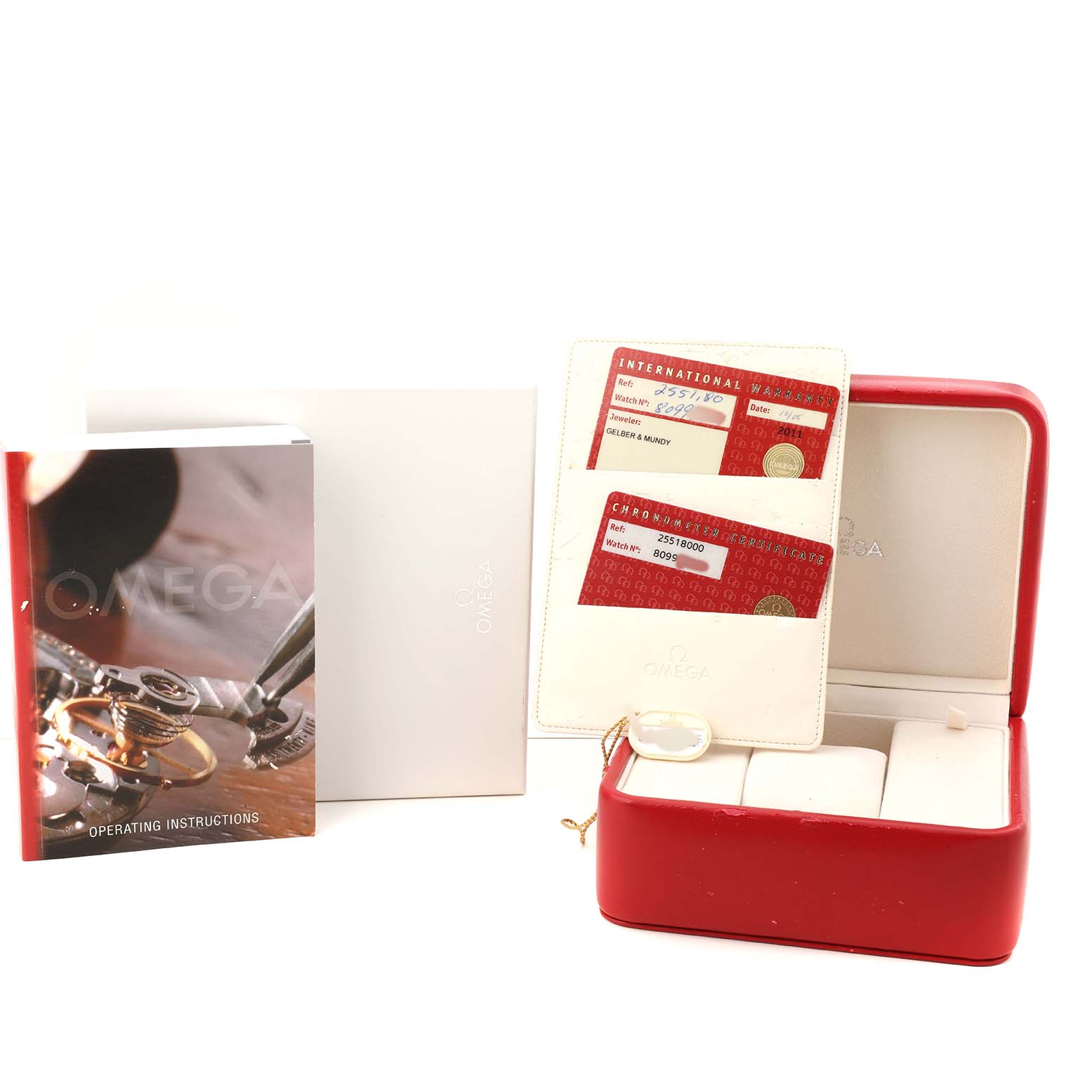 The image shows the Omega Seamaster 2551.80.00 Men's Stainless Steel Blue Dial packaging, including a red watch box, instruction manual, and warranty cards.