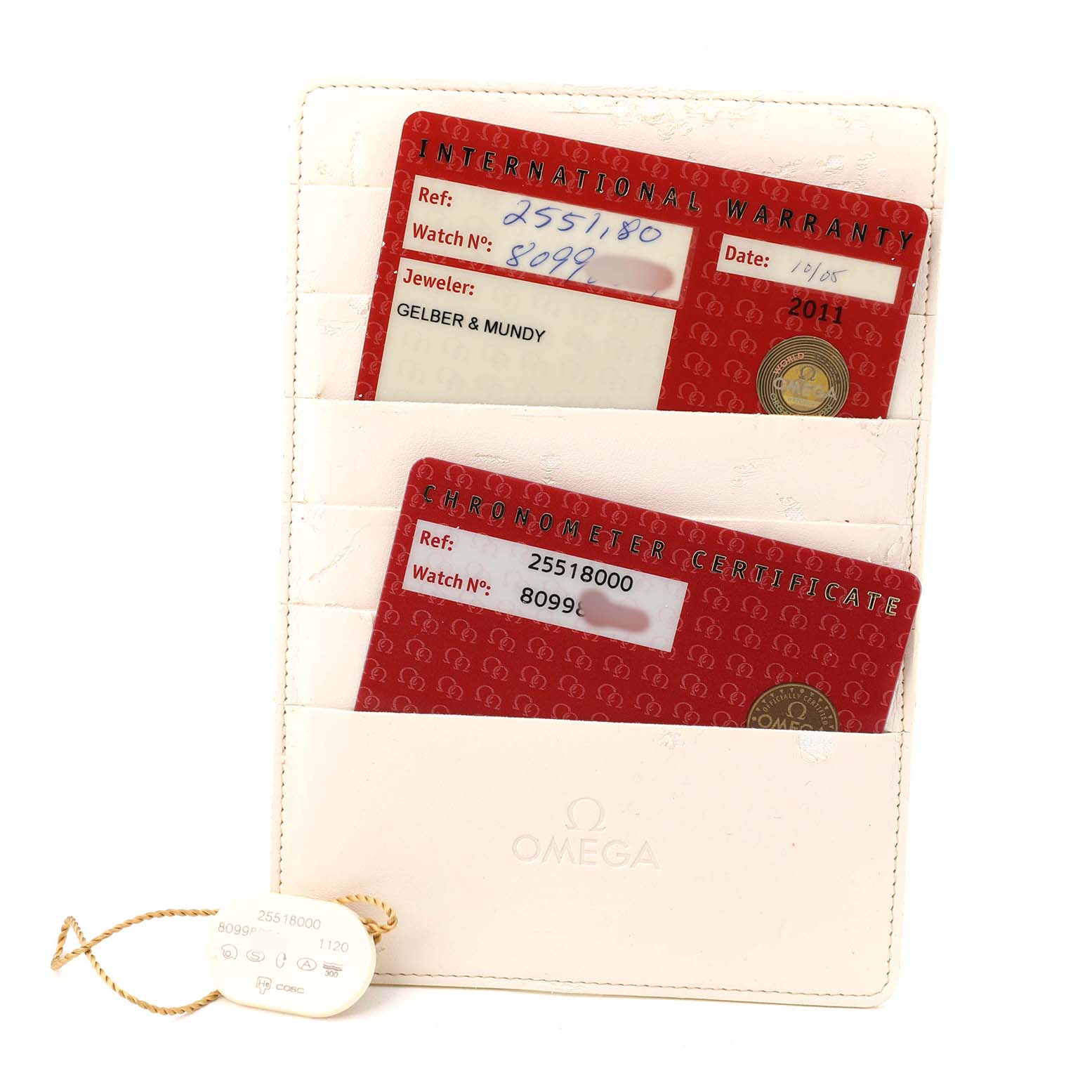 The image displays the warranty cards and a tag for an Omega Seamaster 2551.80.00 Men's Stainless Steel Blue Dial watch, shown from above.