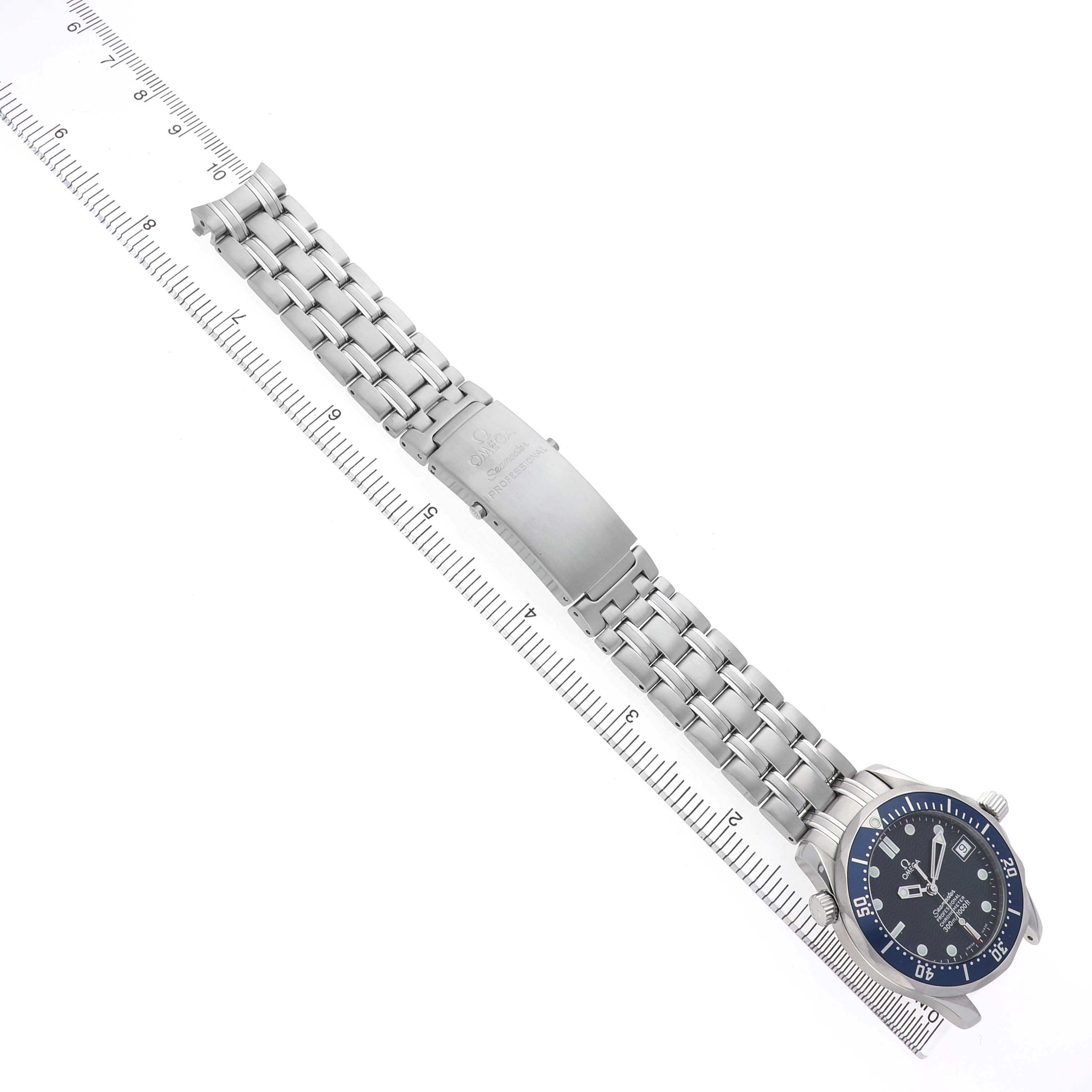 The Omega Seamaster 2551.80.00 Men's Stainless Steel Blue Dial watch is shown from the top view, displaying the face and full bracelet beside a ruler for size reference.