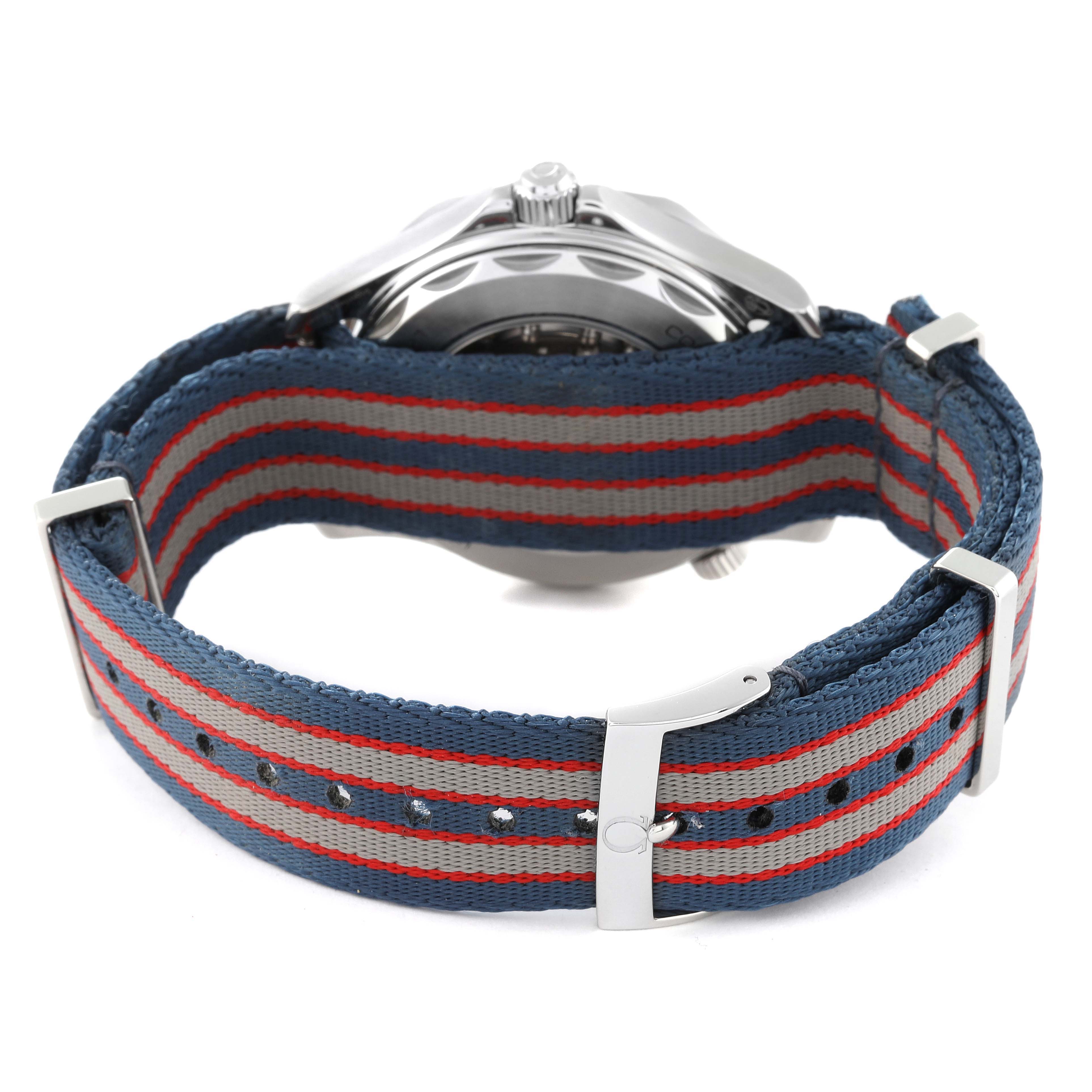 The image shows a rear view of an Omega Seamaster 212.32.41.20.04.001 Men's Stainless Steel White Dial 212.32.41.20.04.001 Men's Stainless Steel White Dial watch with a striped fabric strap and stainless steel hardware.