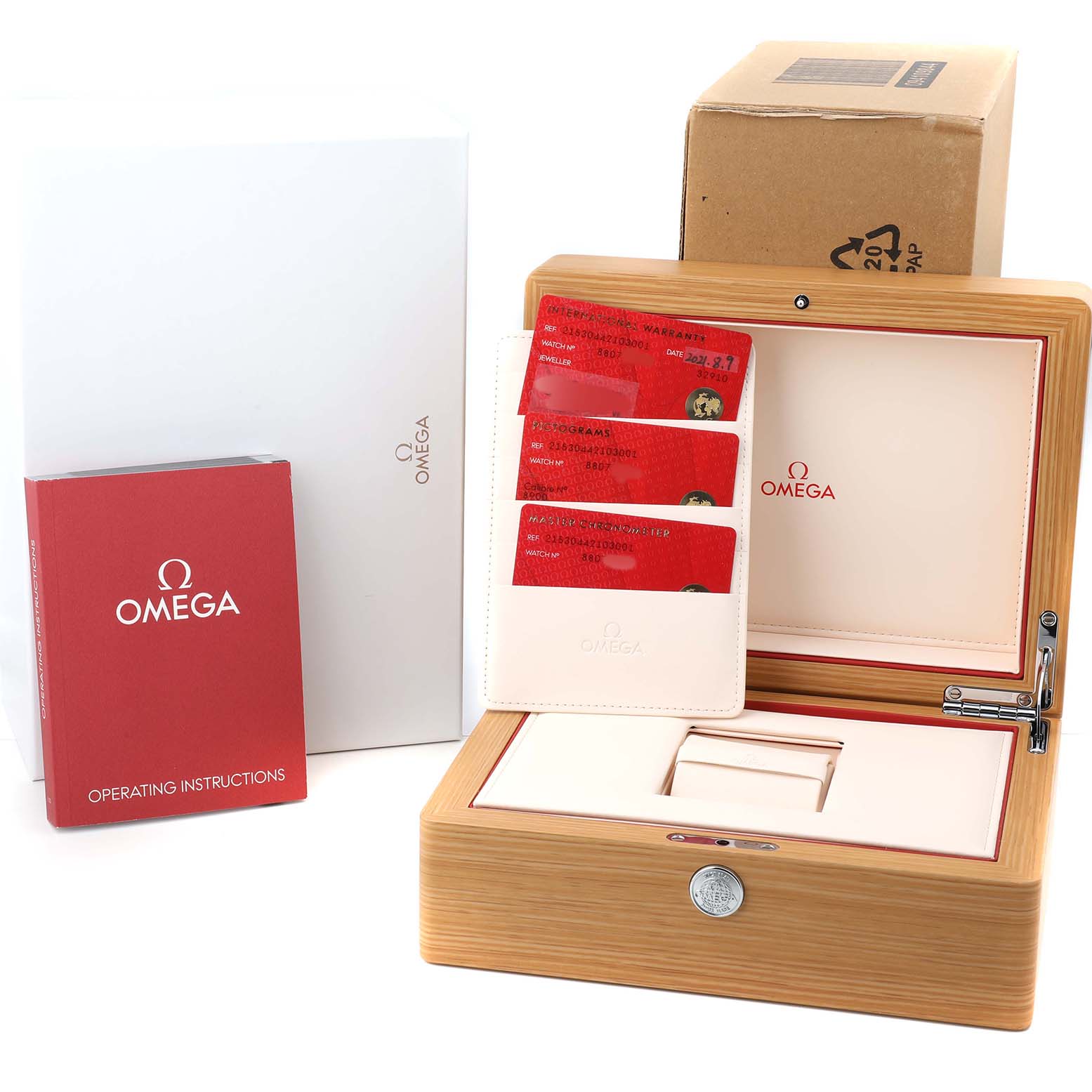 This image shows an Omega Planet Ocean 215.30.44.21.03.001 Men's Stainless Steel Blue Dial watch box, operating manual, cards, and packaging from a front angle.