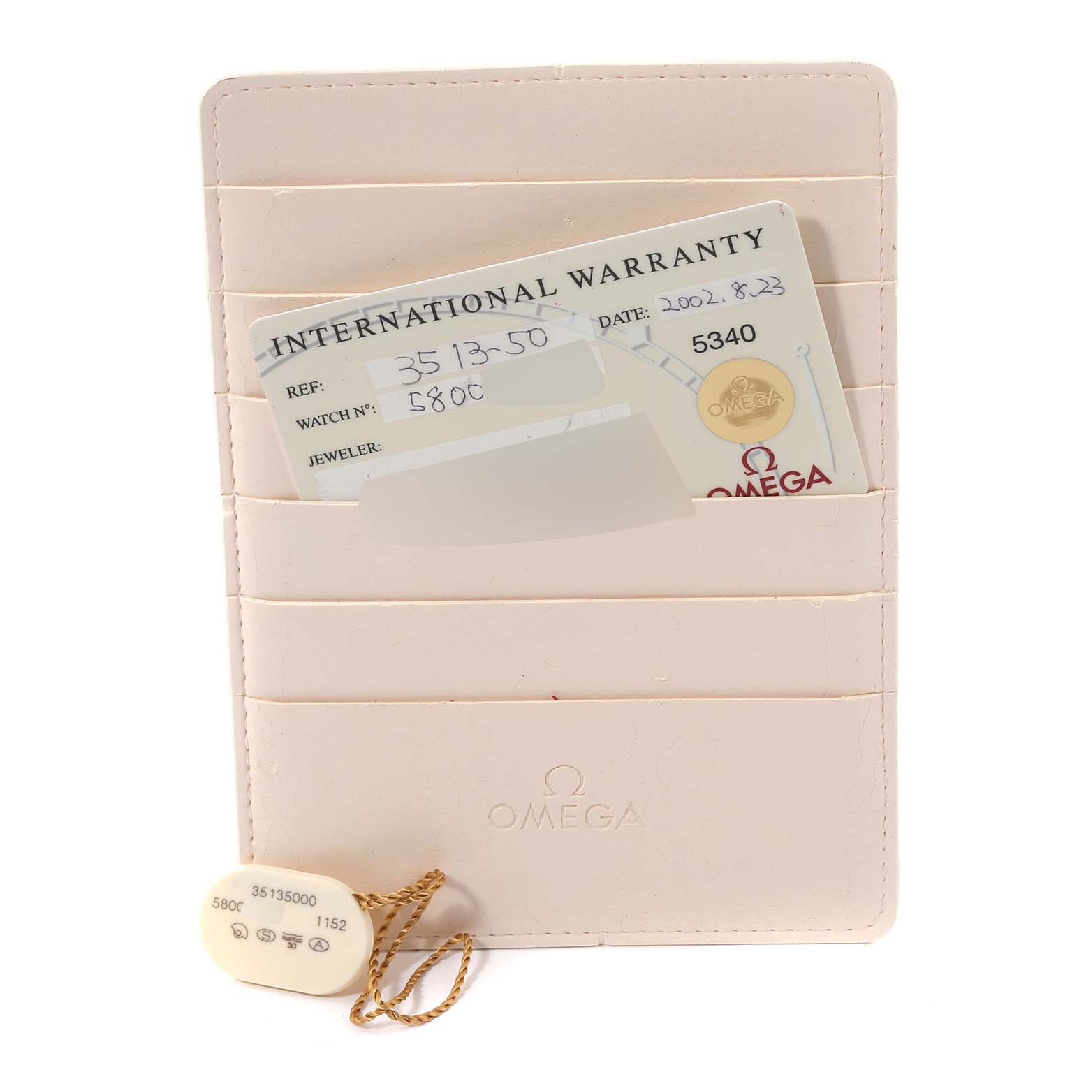 The image shows the warranty card and a hang tag for an Omega Speedmaster 3513.50.00 Men
s Stainless Steel Black Dial 3513.50.00 Men
s Stainless Steel Black Dial, presented in a cardholder.