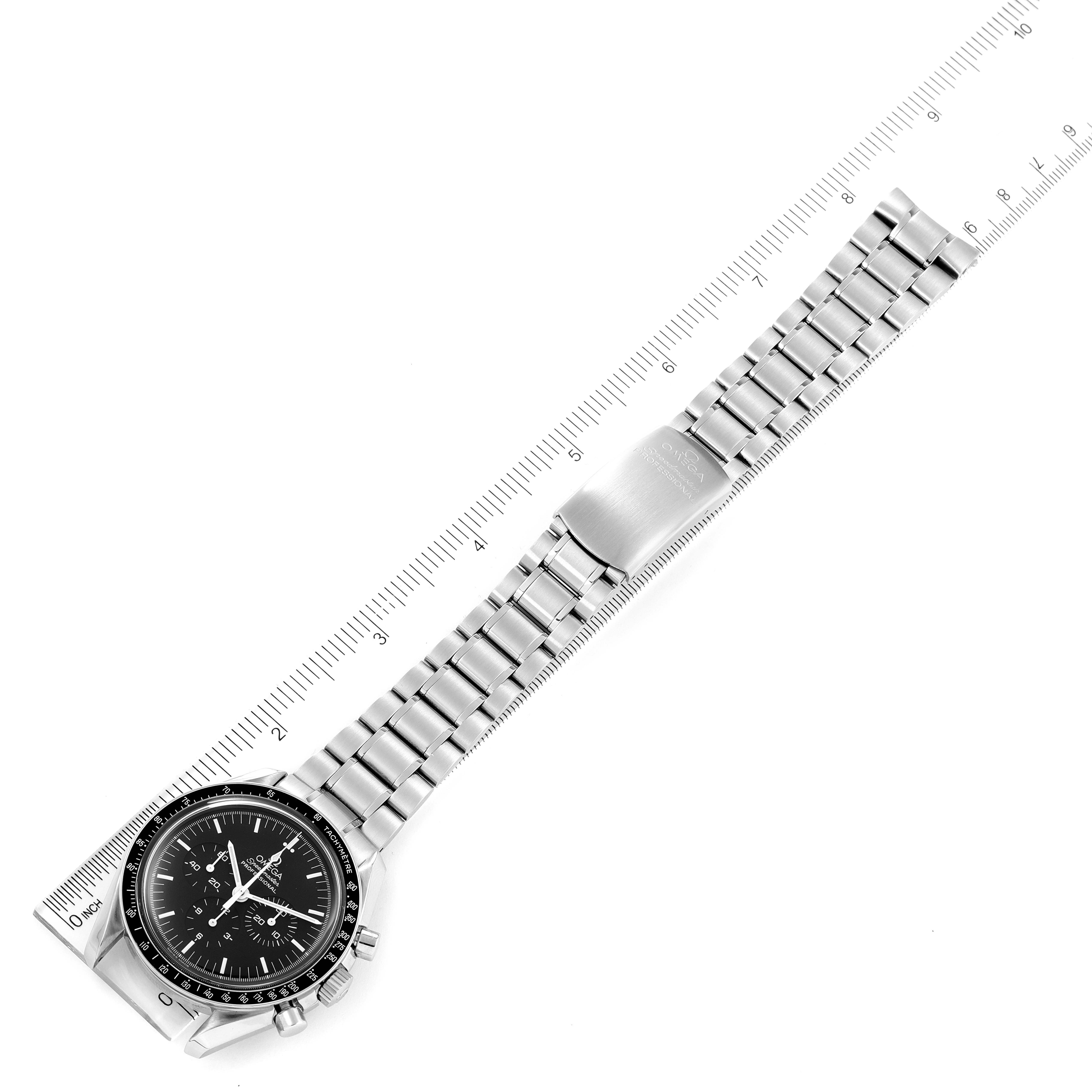 This image shows an Omega Speedmaster 3572.50.00 Men
s Stainless Steel Black Dial 3572.50.00 Men
s Stainless Steel Black Dial watch laid flat with a ruler for scale, displaying the face and full metal bracelet.