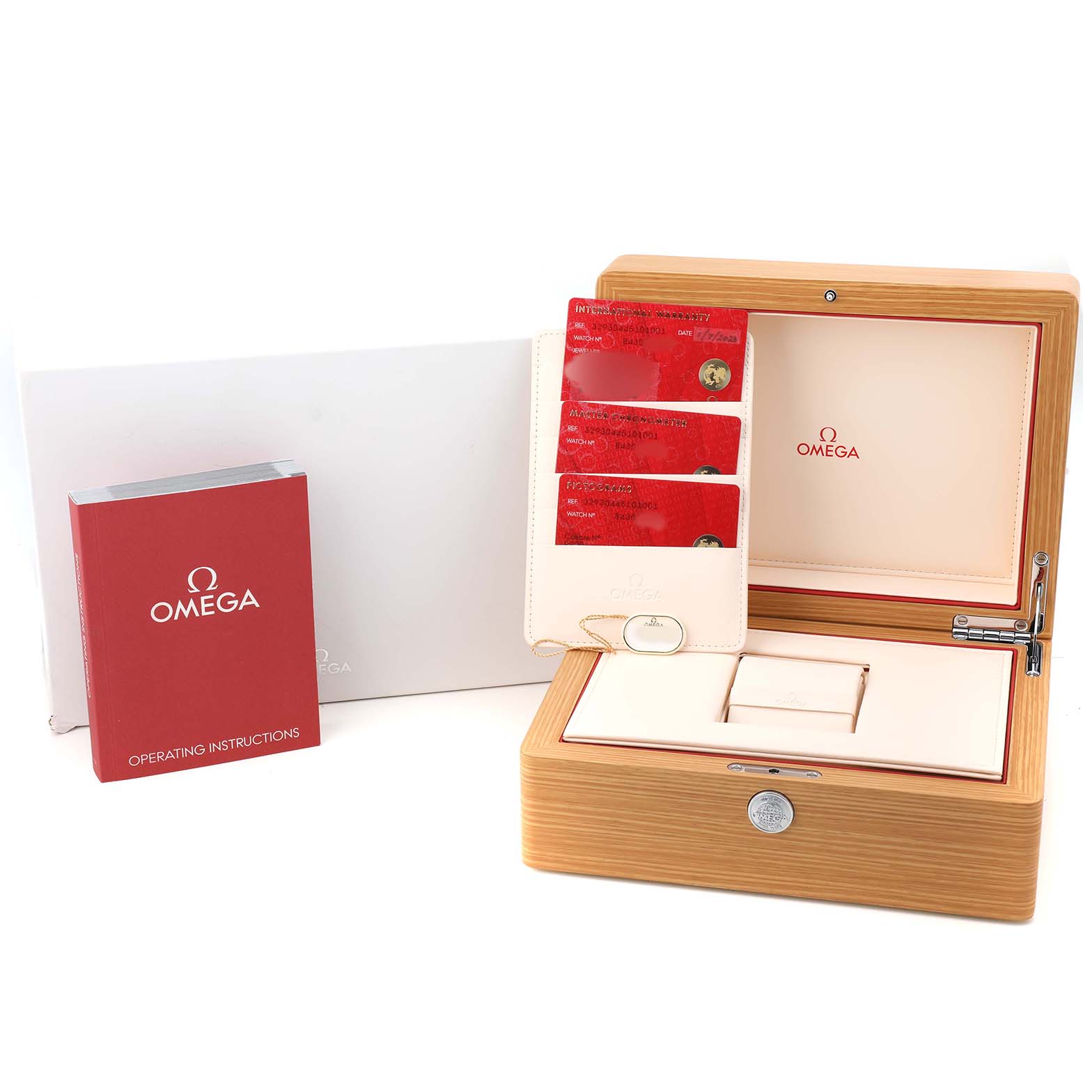 This image shows the Omega Speedmaster 329.30.44.51.01.001 Men's Stainless Steel Black Dial's wooden box, warranty cards, and instruction manual from a top angle.