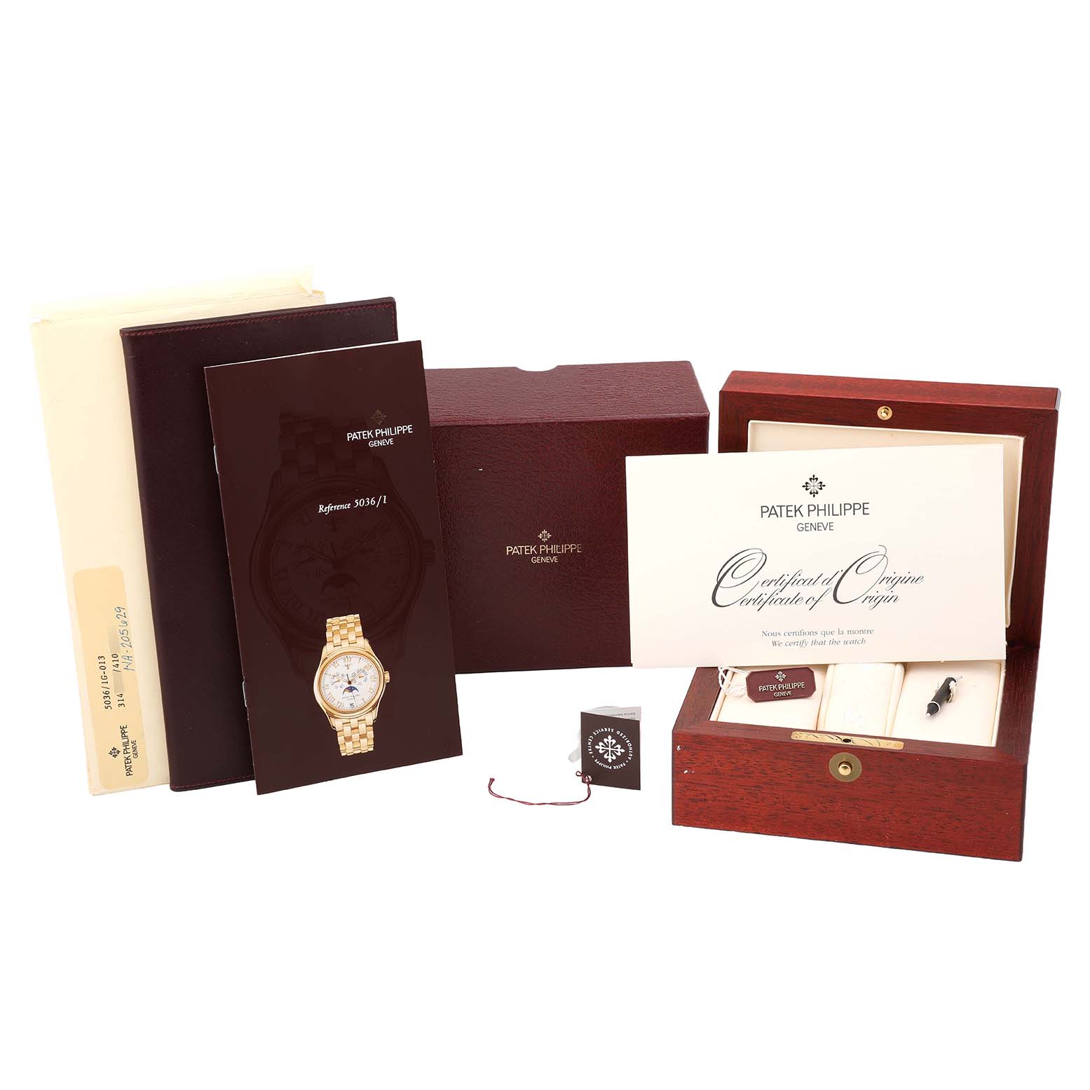 The image shows a Patek Philippe Complications 5036/1G-013 Men's White Gold Silver Dial model with its accessories, including a box, manual, and certificate from a frontal angle.