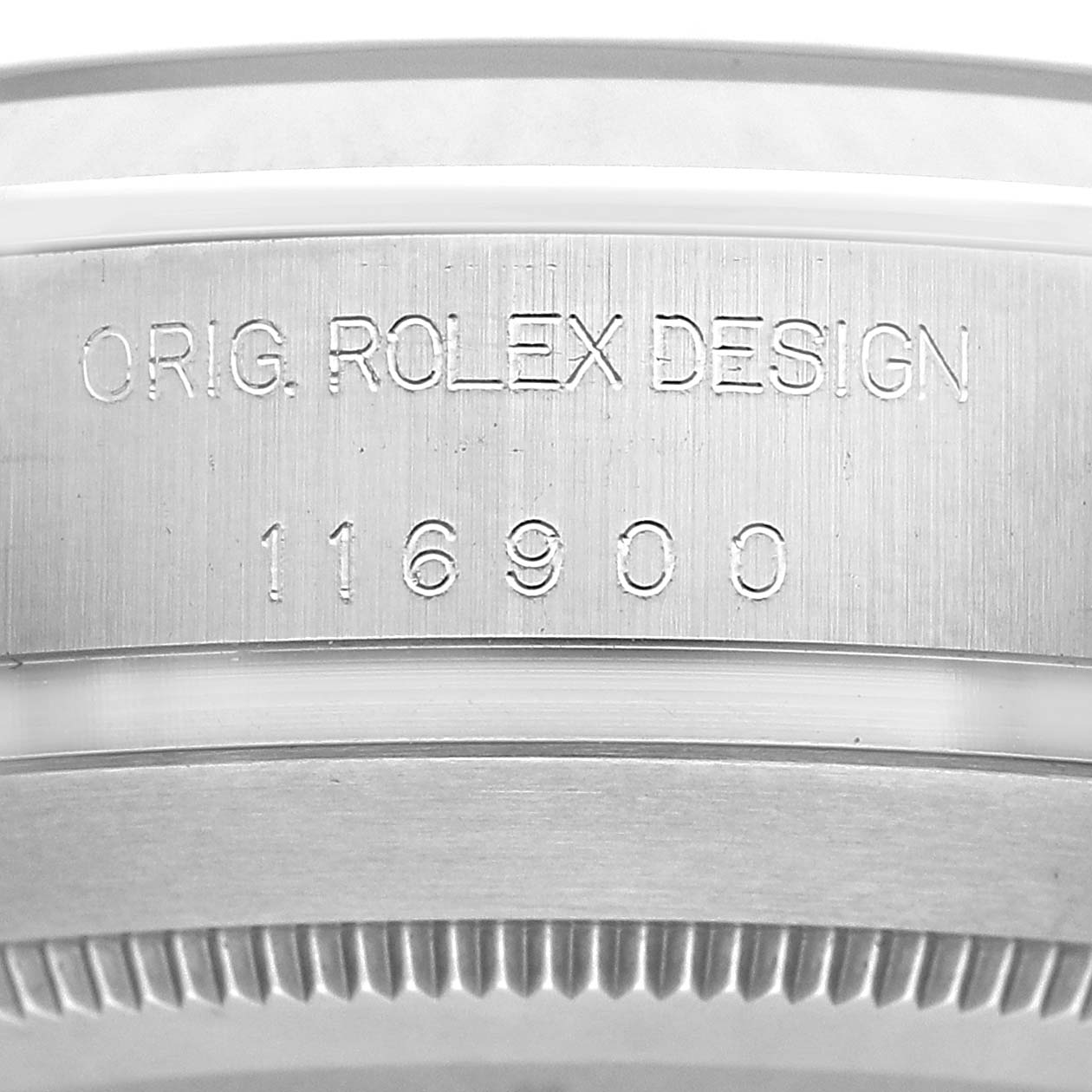 The image shows a close-up of the serial number and "ORIG. ROLEX DESIGN" engraving on the Rolex Air-King 116900 Men's Stainless Steel Black Dial case back.