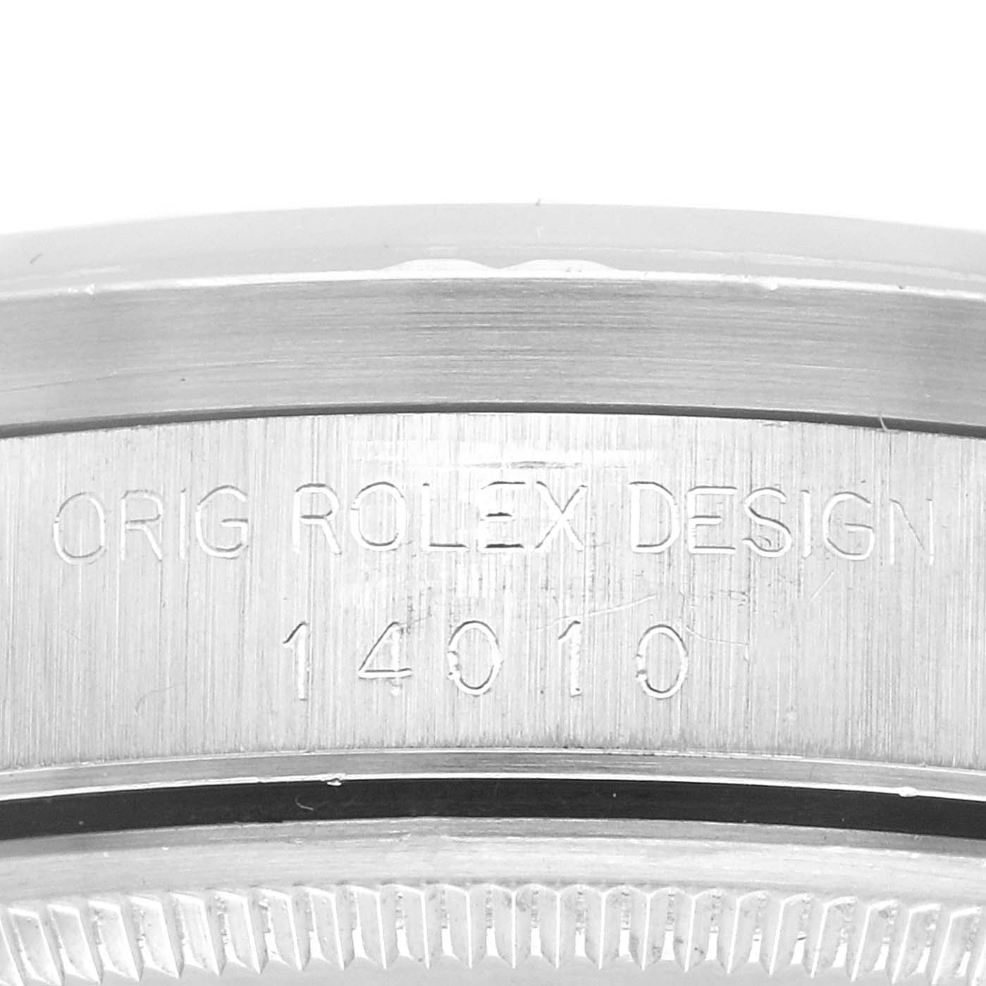 The image shows a close-up of the side engraving on a Rolex Air-King 14010 Men's Stainless Steel Blue Dial 14010 Men's Stainless Steel Blue Dial, featuring the text "ORIG ROLEX DESIGN 14010."