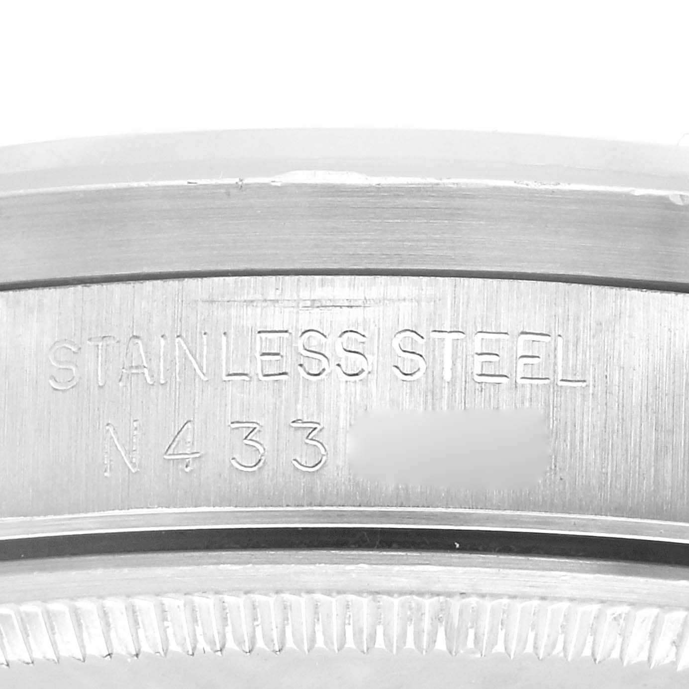 This image shows a close-up of the side of a Rolex Air-King 14010 Men's Stainless Steel Blue Dial 14010 Men's Stainless Steel Blue Dial watch, specifically highlighting the stainless steel casing and part of the serial number.