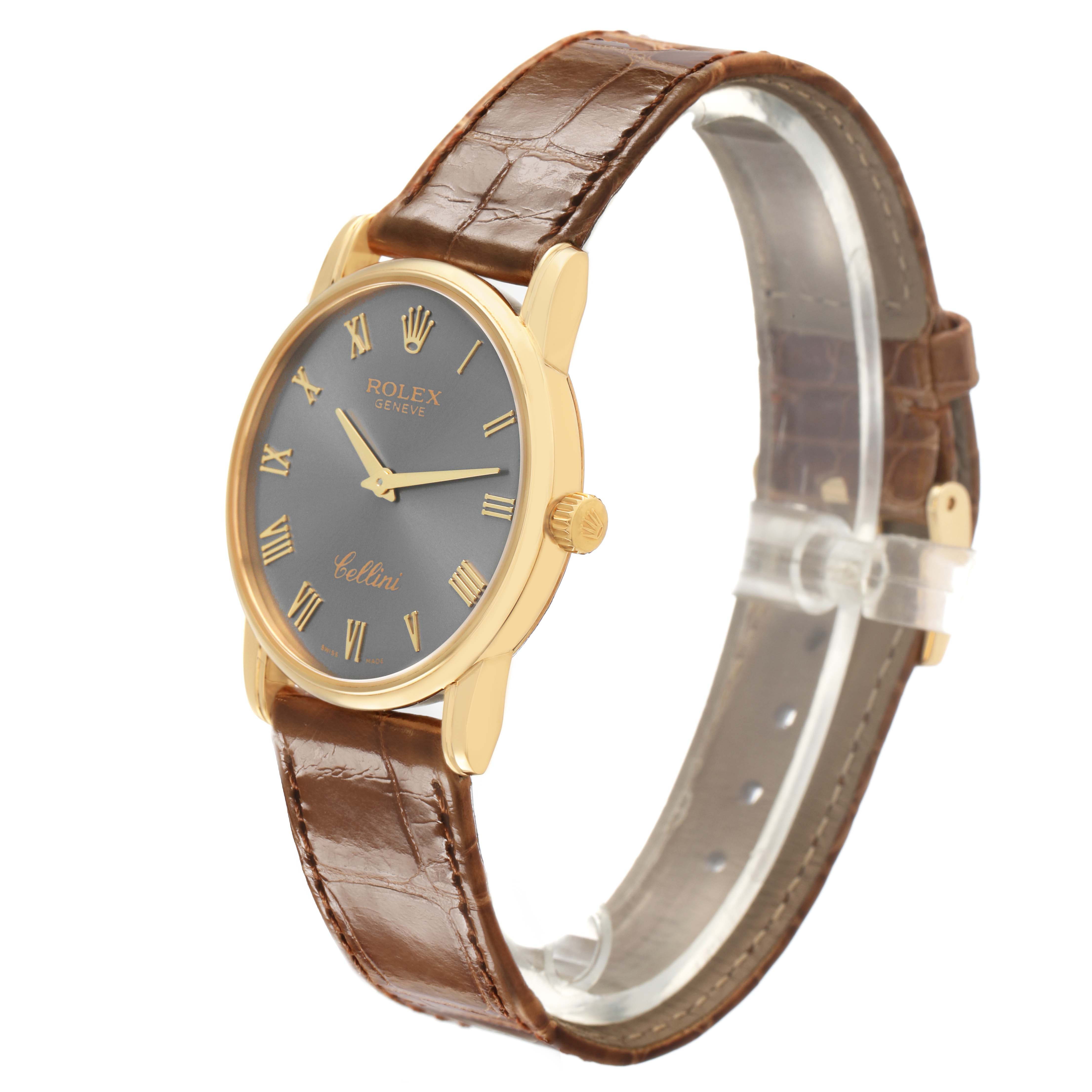 The Rolex Cellini 5116 Men's Yellow Gold Grey Dial watch is shown at a side angle highlighting its face, gold case, and brown leather strap.