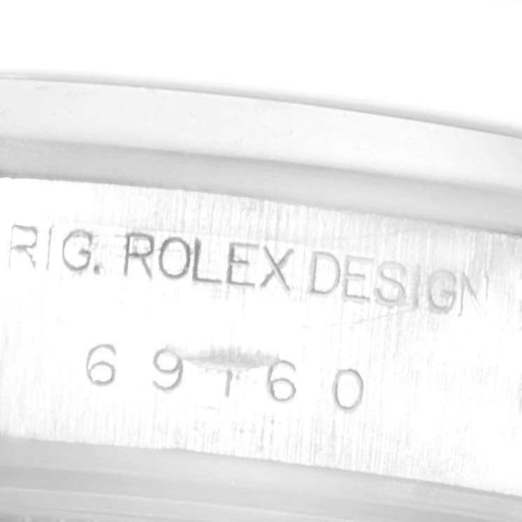 This close-up image shows the engraved model and brand on the case of a Rolex Date 69160 Women's Stainless Steel Black Dial 69160 Women's Stainless Steel Black Dial watch.