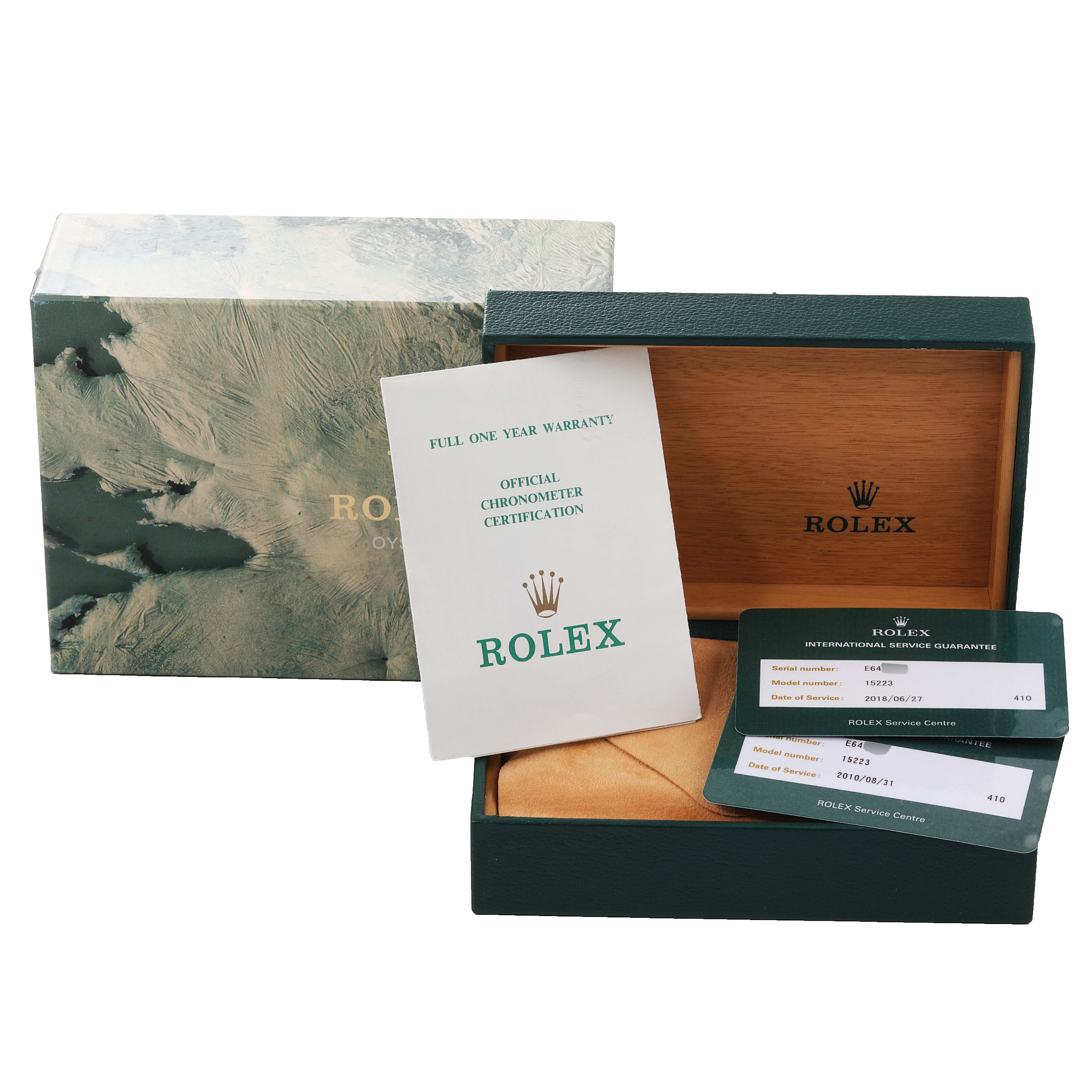 The image shows a Rolex Date 15223 Men's Steel and Gold (two tone) Silver Dial 15223 Men's Steel and Gold (two tone) Silver Dial model box, warranty card, certification booklet, and international service guarantee cards.