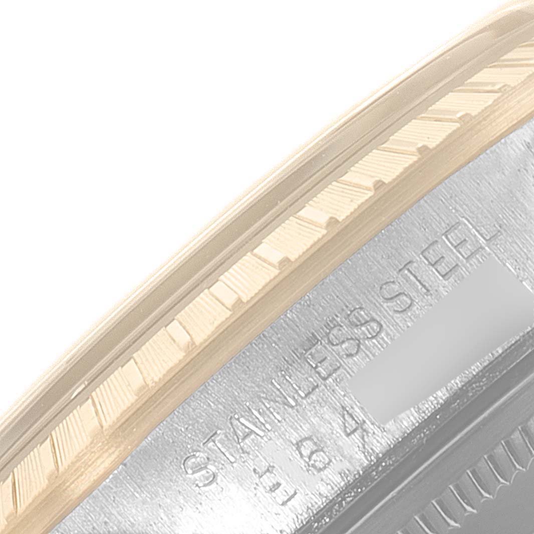 The image shows a close-up of the bezel and part of the caseback of a Rolex Date 15223 Men's Steel and Gold (two tone) Silver Dial 15223 Men's Steel and Gold (two tone) Silver Dial model, highlighting its stainless steel construction.