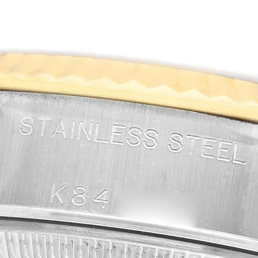 The image shows a close-up of the Rolex Datejust 79173 Women's Steel and Gold (two tone) Champagne Dial’s case edge, highlighting “STAINLESS STEEL” engraving.