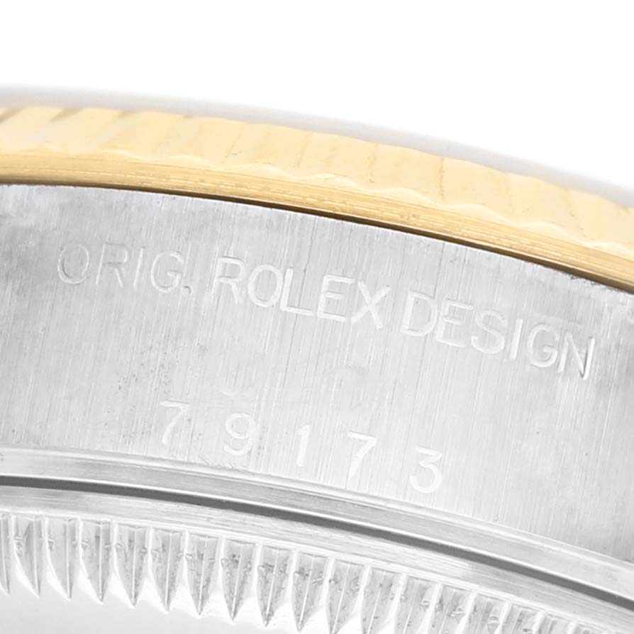 The image shows a close-up of the side of a Rolex Datejust 79173 Women's Steel and Gold (two tone) Champagne Dial watch, highlighting the engraved model number.