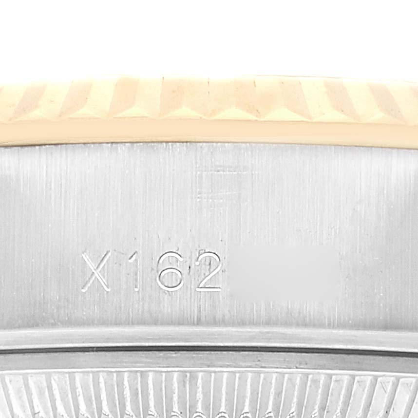 This is a close-up view of the serial number engraving on the case of a Rolex Datejust 69173 Women's Steel and Gold (two tone) Black Dial 69173 Women's Steel and Gold (two tone) Black Dial watch.