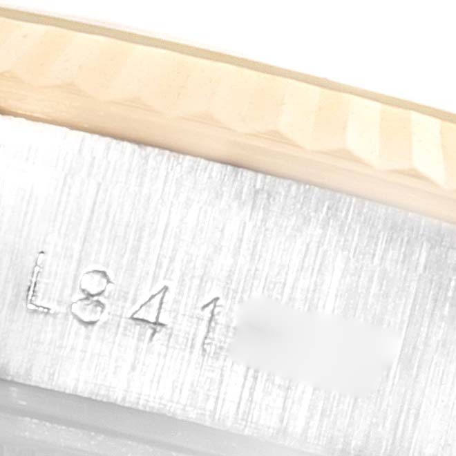 The image shows a close-up of the side of the bezel and part of the serial number of a Rolex Datejust 69173 Women's Steel and Gold (two tone) Champagne Dial 69173 Women's Steel and Gold (two tone) Champagne Dial watch.