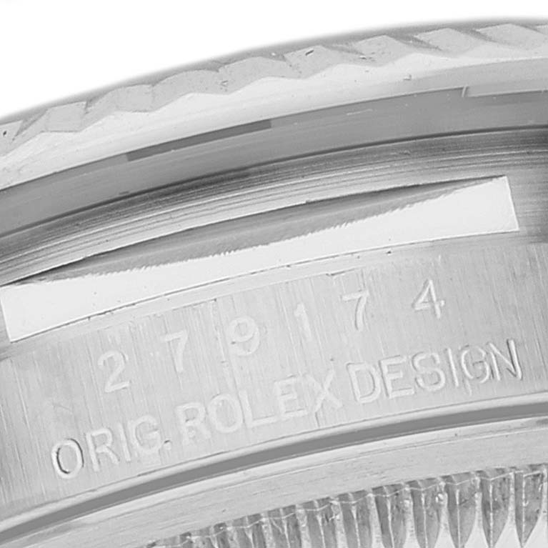 This image shows a close-up of the case edge of a Rolex Datejust 279174 Women's Stainless Steel Grey Dial 279174 Women's Stainless Steel Grey Dial watch, highlighting the serial number and "ORIG. ROLEX DESIGN" engraving.