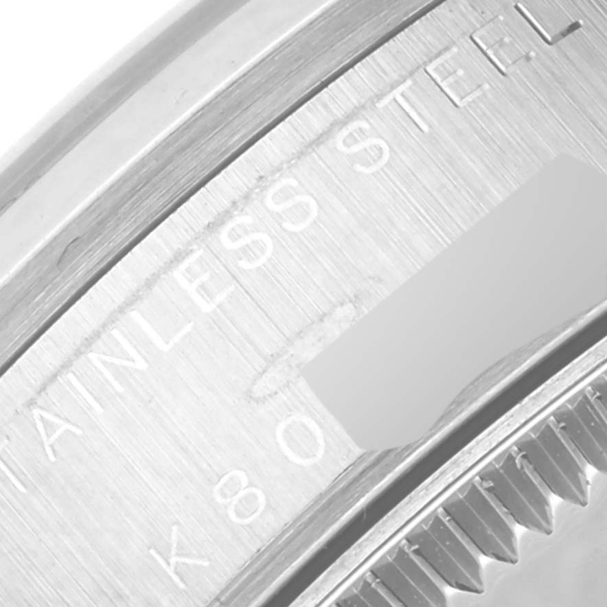 Close-up of the side inscription near the bezel of a Rolex Mid-Size 78240 Women's Stainless Steel Pink Dial 78240 Women's Stainless Steel Pink Dial model watch, showing parts of the text "STAINLESS STEEL".
