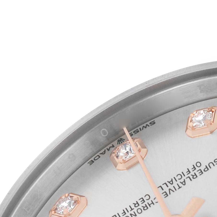 This close-up shows the dial edge, markers, and part of the bezel of a Mid-Size Rolex watch.