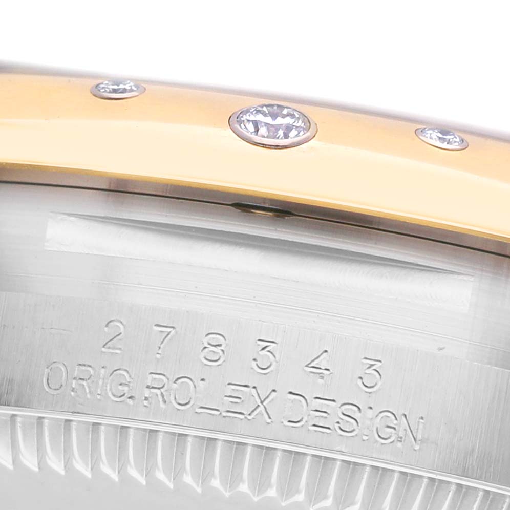 The image shows a close-up of a Rolex Mid-Size 278343 Women's Steel and Gold (two tone) Grey Dial model's bezel with diamond accents and the engraved design number on the case side.