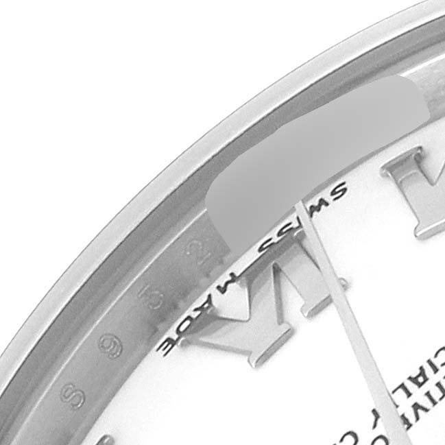 The image shows a close-up of the dial and bezel of a Mid-Size Rolex watch, including part of the watch
s Roman numerals and the "Swiss Made" label.