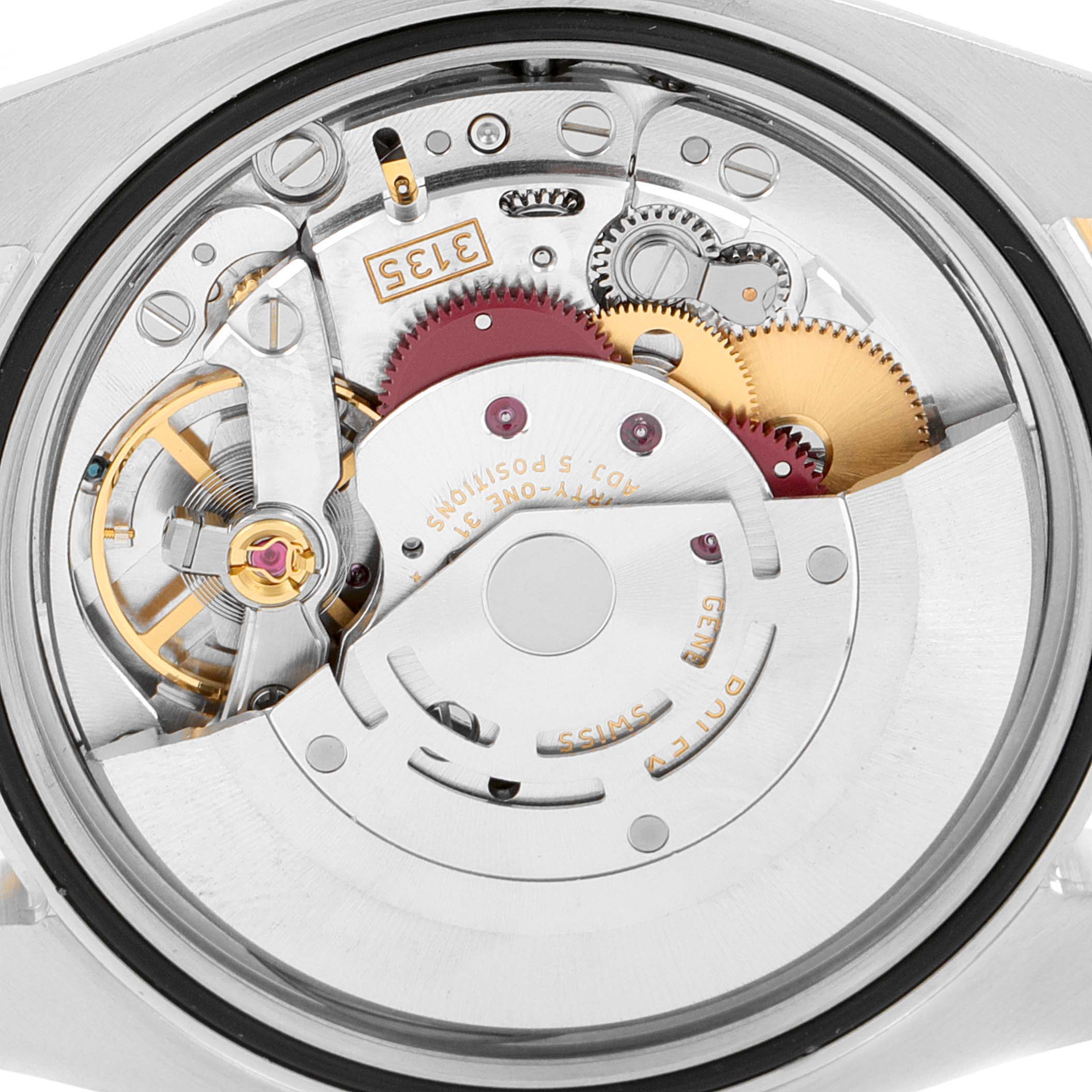 The image shows a close-up view of the movement mechanism of a Rolex Datejust 116243 Men's Steel and Gold (two tone) Silver Dial 116243 Men's Steel and Gold (two tone) Silver Dial watch, revealing gears and intricate components.