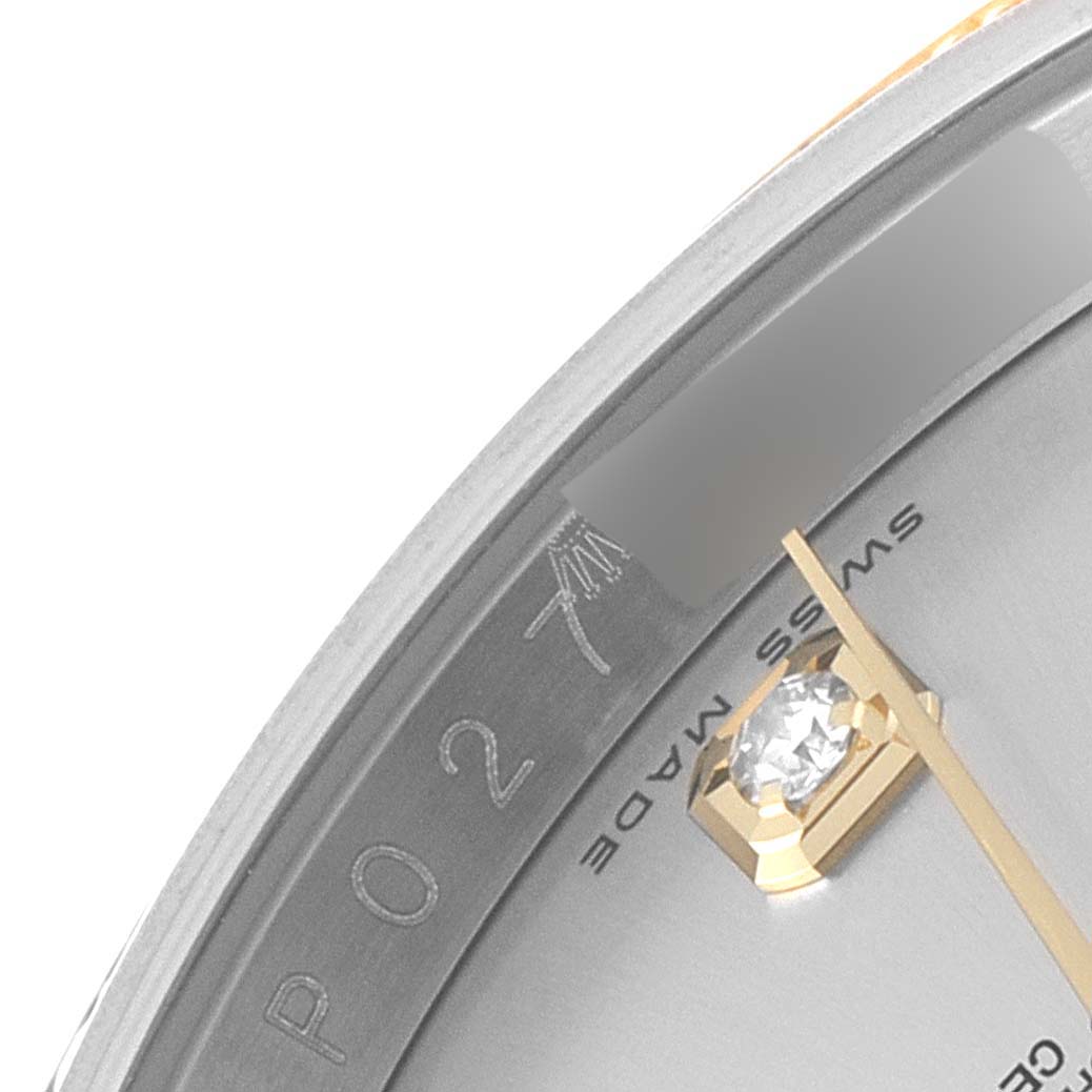 This close-up of a Rolex Datejust 116243 Men's Steel and Gold (two tone) Silver Dial 116243 Men's Steel and Gold (two tone) Silver Dial watch shows part of the dial with "SWISS MADE" text, a diamond marker, and a portion of the second hand.