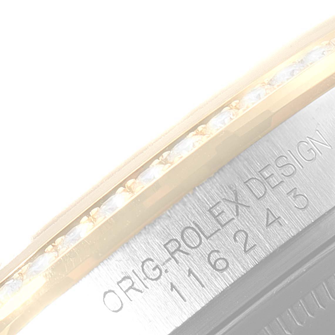 This image shows a close-up angle of the bezel and part of the case engraving of a Rolex Datejust 116243 Men's Steel and Gold (two tone) Silver Dial 116243 Men's Steel and Gold (two tone) Silver Dial watch.