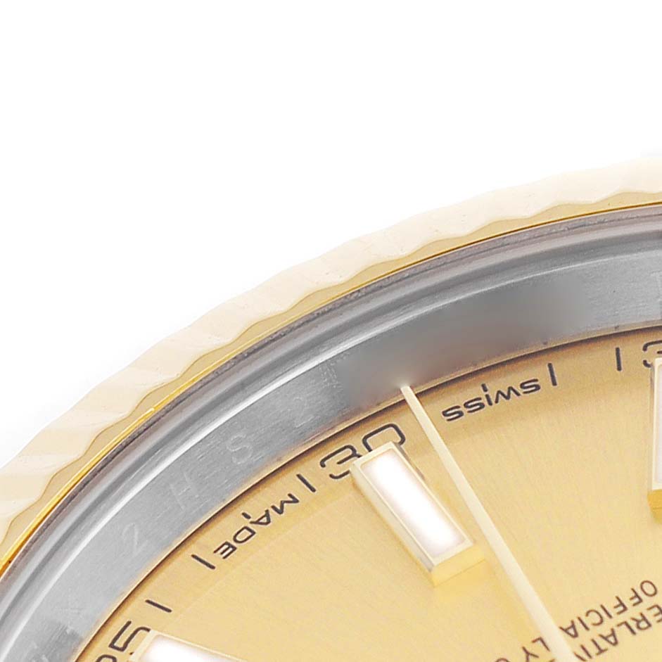 The image shows a partial close-up of the Rolex Datejust 41 126333 Men's Steel and Gold (two tone) Champagne Dial's dial, chapter ring, and edge of the bezel.