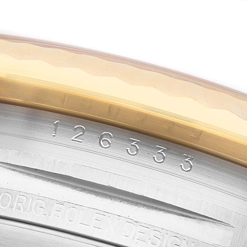The image shows an angled close-up of the Rolex Datejust 41 126333 Men's Steel and Gold (two tone) Champagne Dial, focusing on the case edge and engraved serial number.