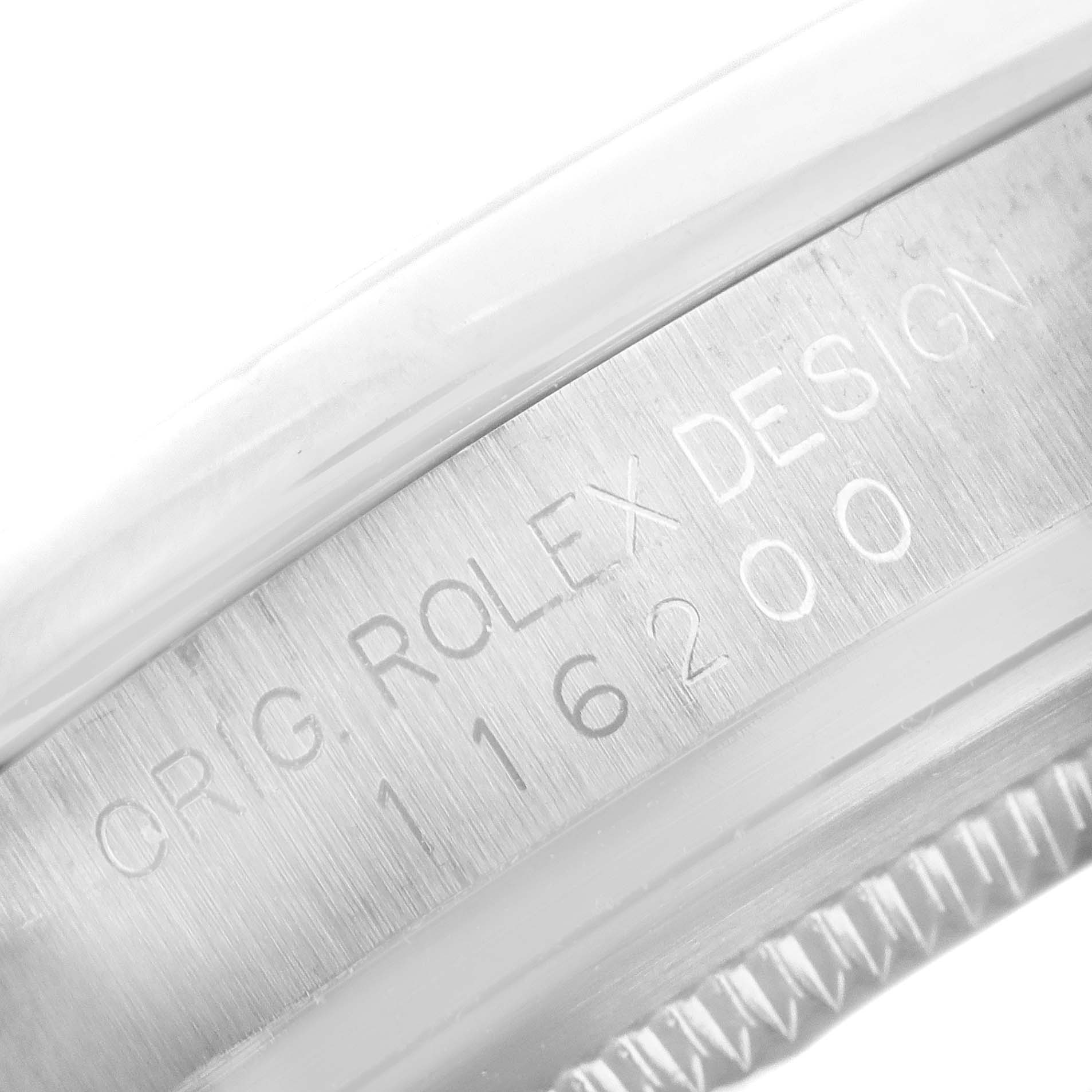 The image shows a close-up of the case with engraved text on a Rolex Datejust 116200 Men's Stainless Steel Black Dial 116200 Men's Stainless Steel Black Dial model.