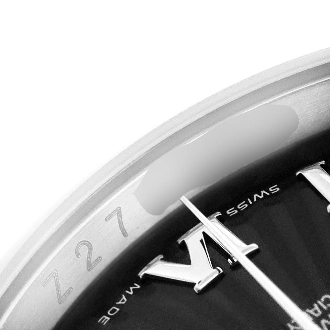 This close-up image shows the dial and rehaut of a Rolex Datejust 116200 Men's Stainless Steel Black Dial 116200 Men's Stainless Steel Black Dial watch, including part of a Roman numeral marker.