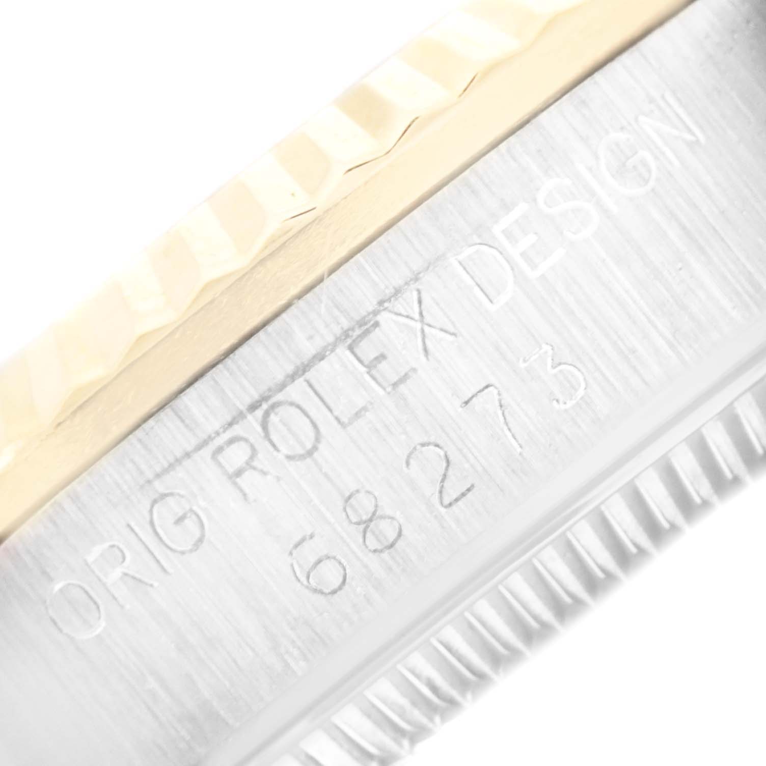 This image shows a close-up of the side of a Mid-Size Rolex watch case, displaying the model number and branding.