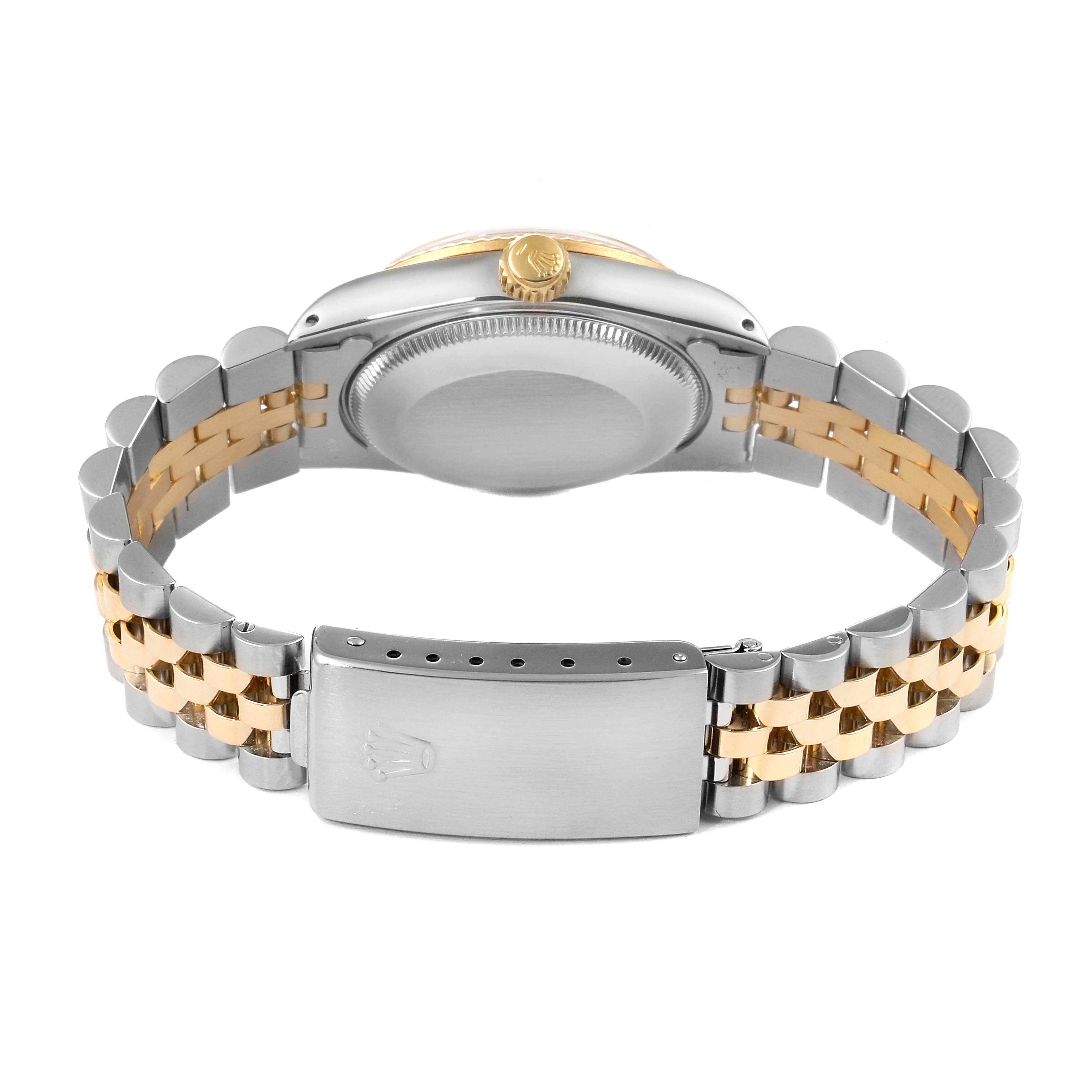 The image shows the bracelet and case back of a mid-size Rolex watch from a rear angle.