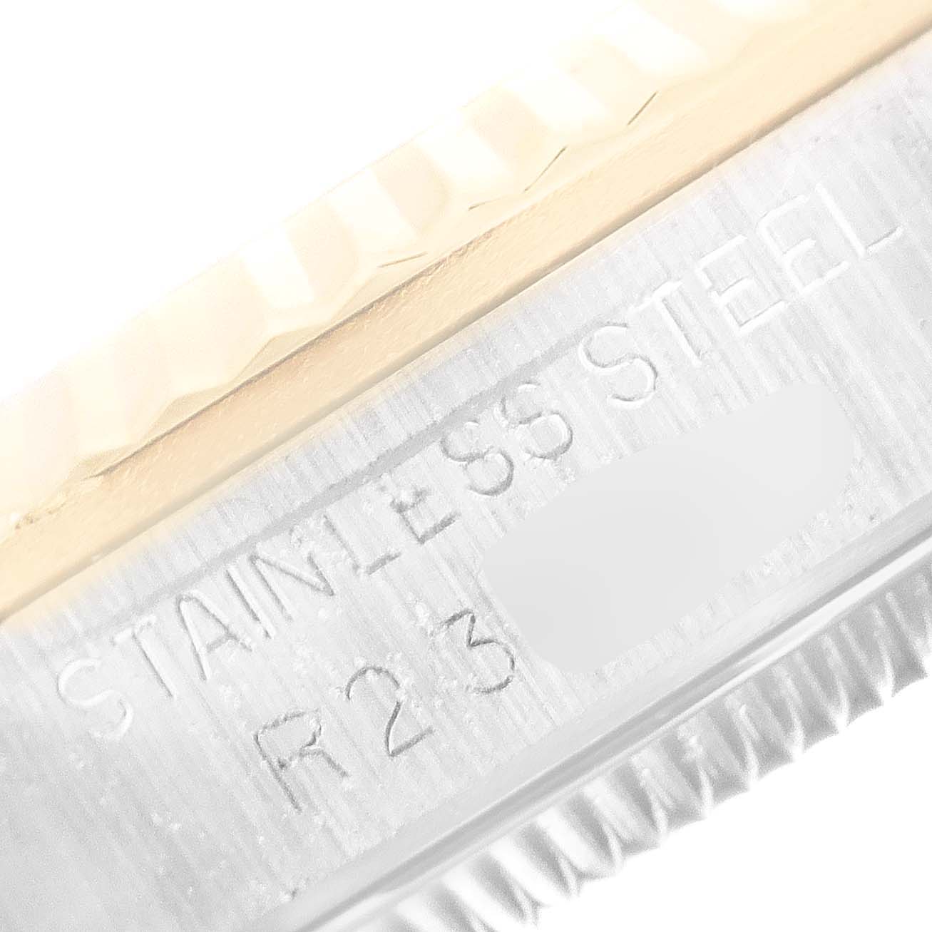 This close-up image showcases the engraved text on the side of the casing for a Rolex Mid-Size 68273 Women's Steel and Gold (two tone) Champagne Dial 68273 Women's Steel and Gold (two tone) Champagne Dial model made of stainless steel.