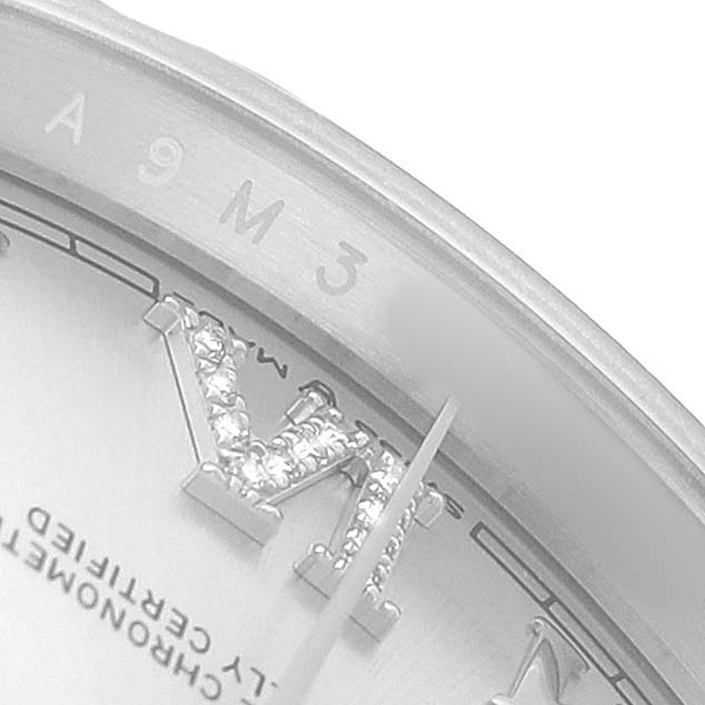 This close-up of the Rolex Datejust 126284 Men's Stainless Steel Silver Dial watch shows part of the dial with diamond-set Roman numerals and a portion of the bezel.
