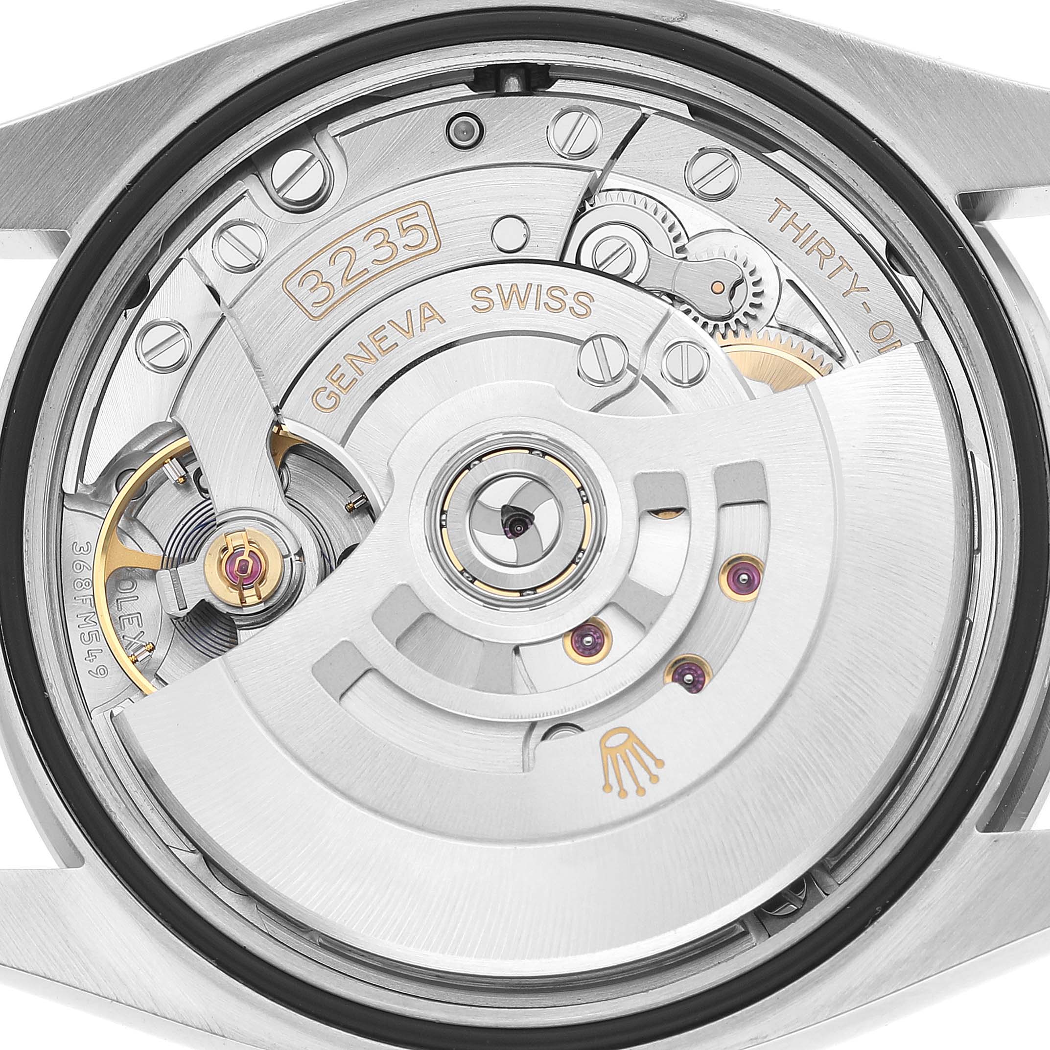 The image shows a close-up of the movement of a Rolex Datejust 126284 Men's Stainless Steel Silver Dial, highlighting its rotor and intricate mechanics.