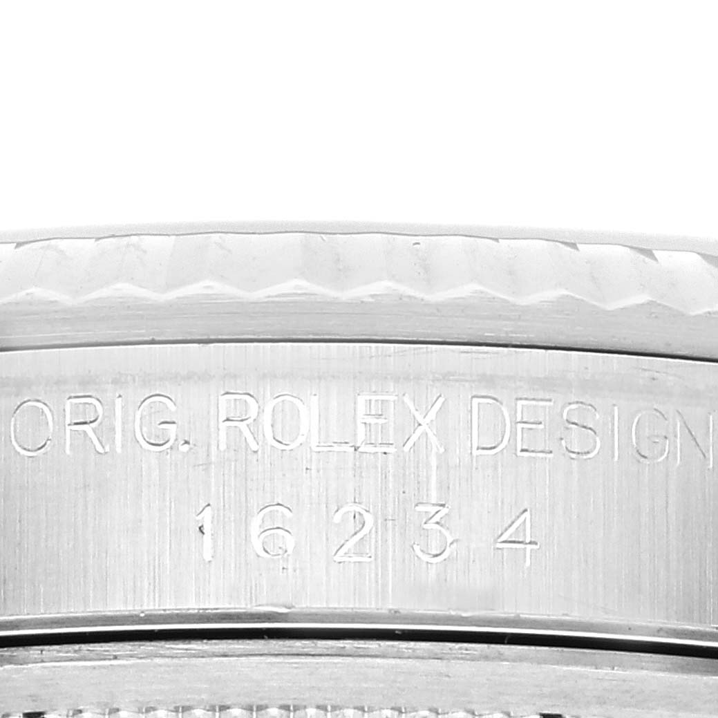This close-up image shows the engraved "ORIG. ROLEX DESIGN 16234" text on the case of the Rolex Datejust 16234 Men's Stainless Steel Black Dial 16234 Men's Stainless Steel Black Dial watch.